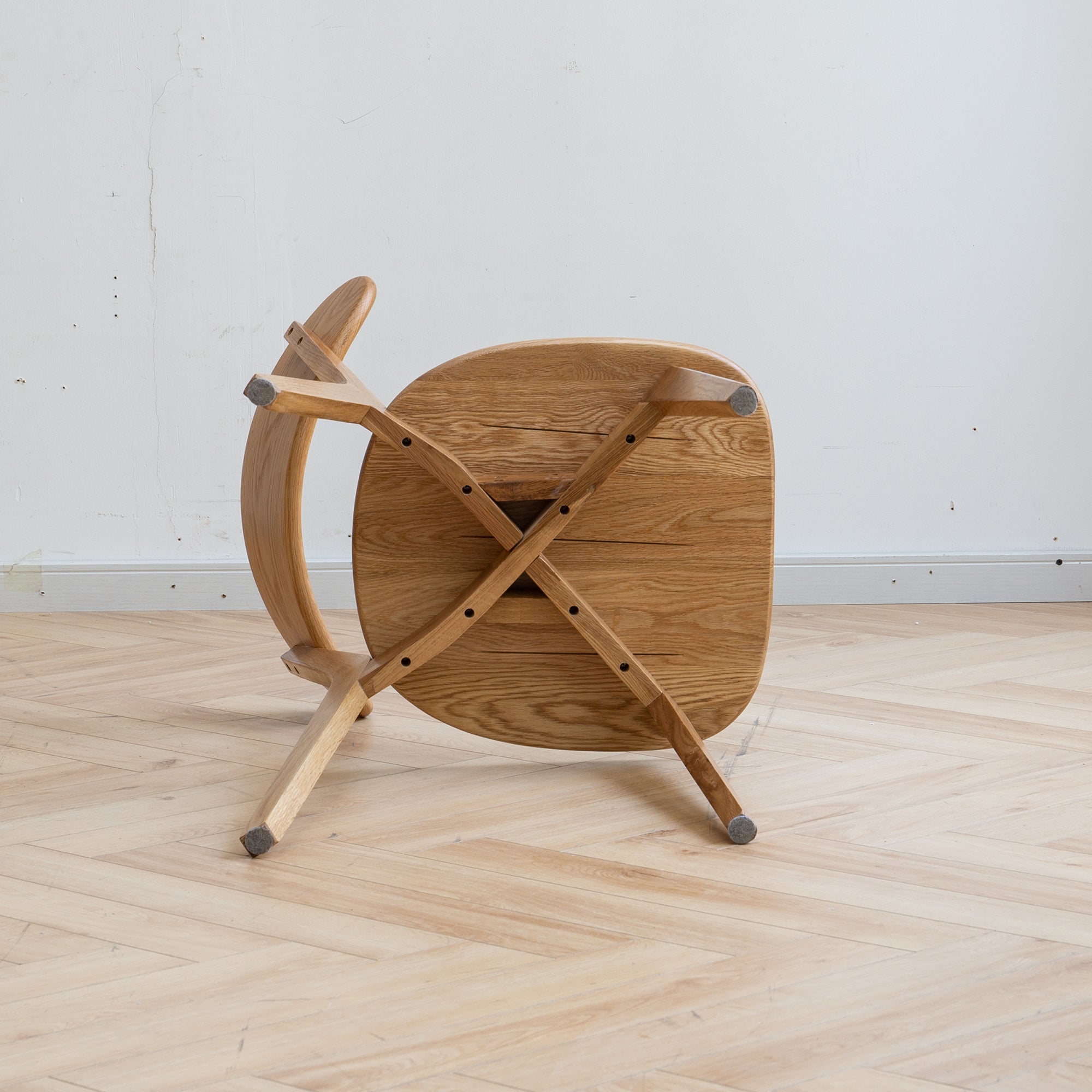 Mogan oak dining chair underside view showing the solid wood seat and support frame construction