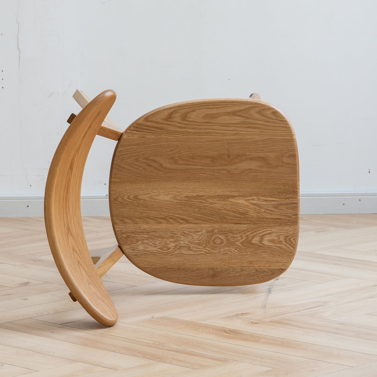 Mogan oak solid wood dining chair underside view showing the curved seat and support frame
