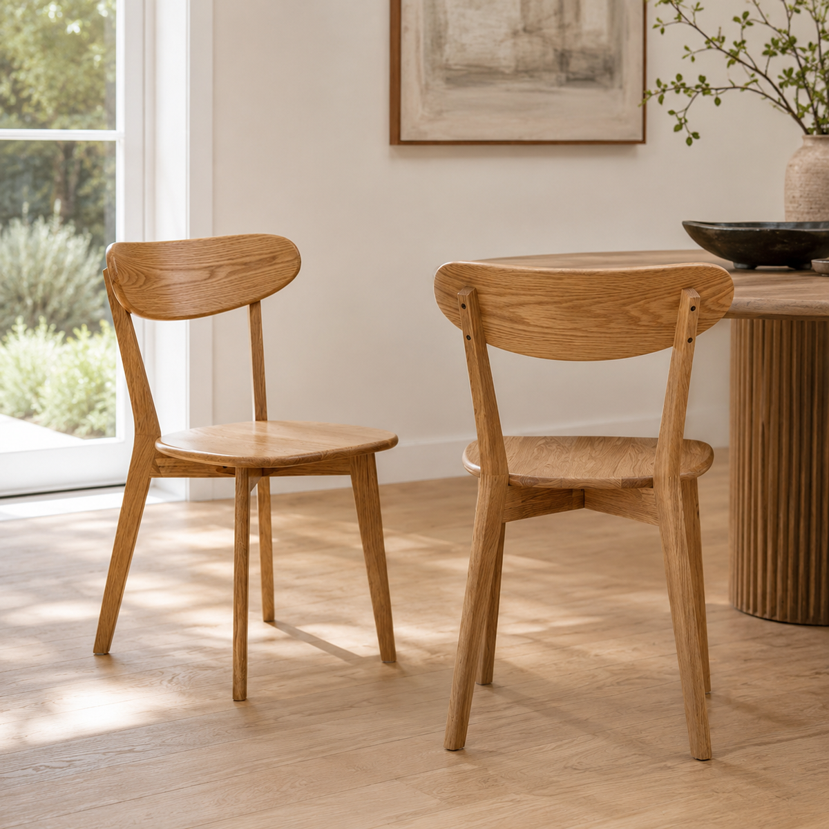 Mogan oak dining chairs set of two in a warm dining space with natural wood flooring