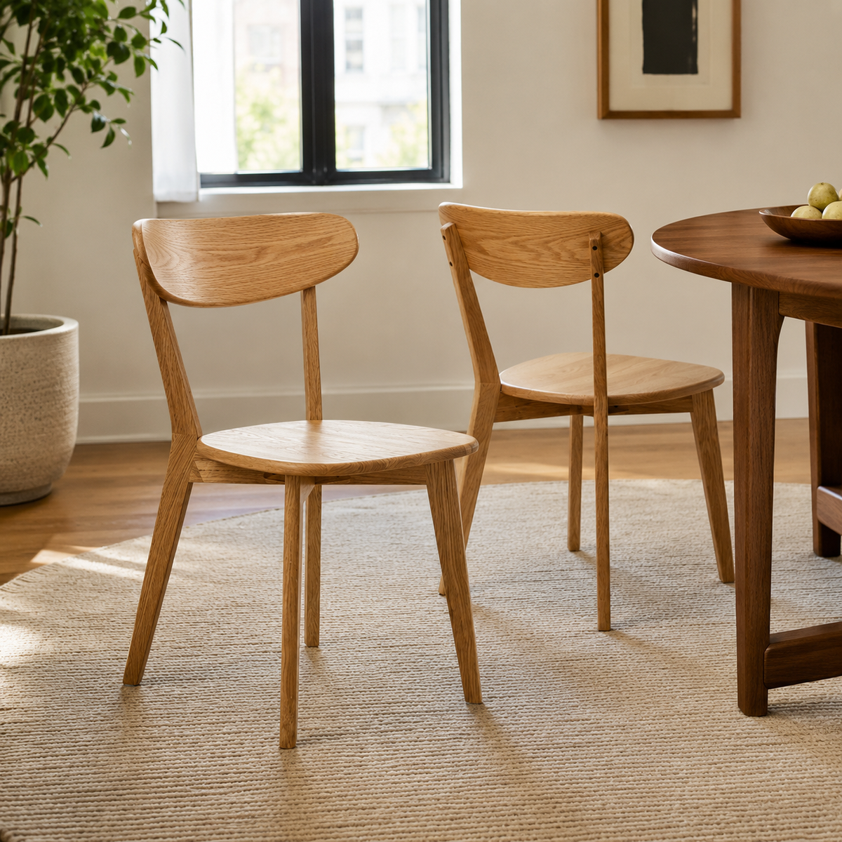 Mogan oak dining chairs around a wood dining table in a cozy minimalist dining area