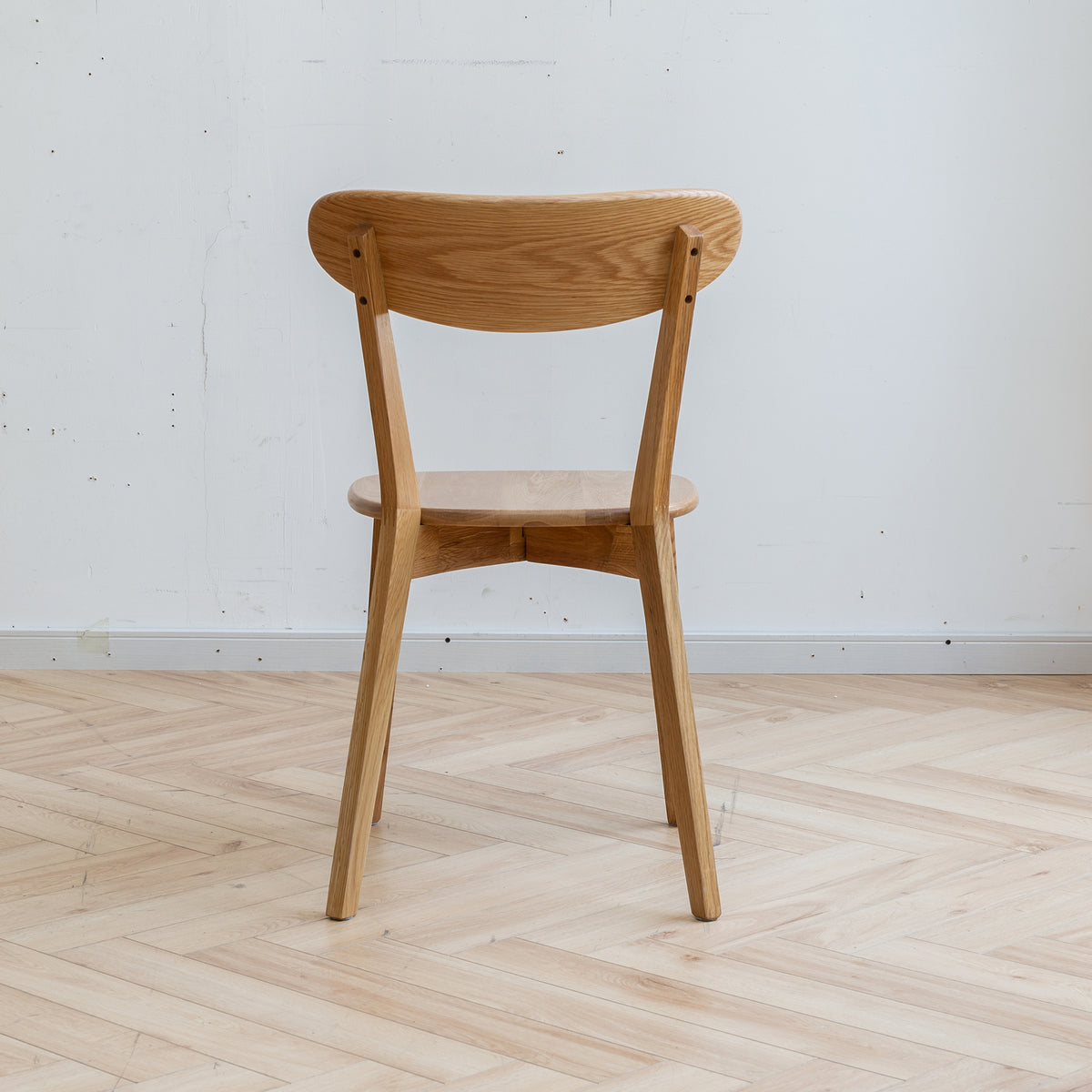 Mogan oak dining chair rear view showing the curved backrest on white background