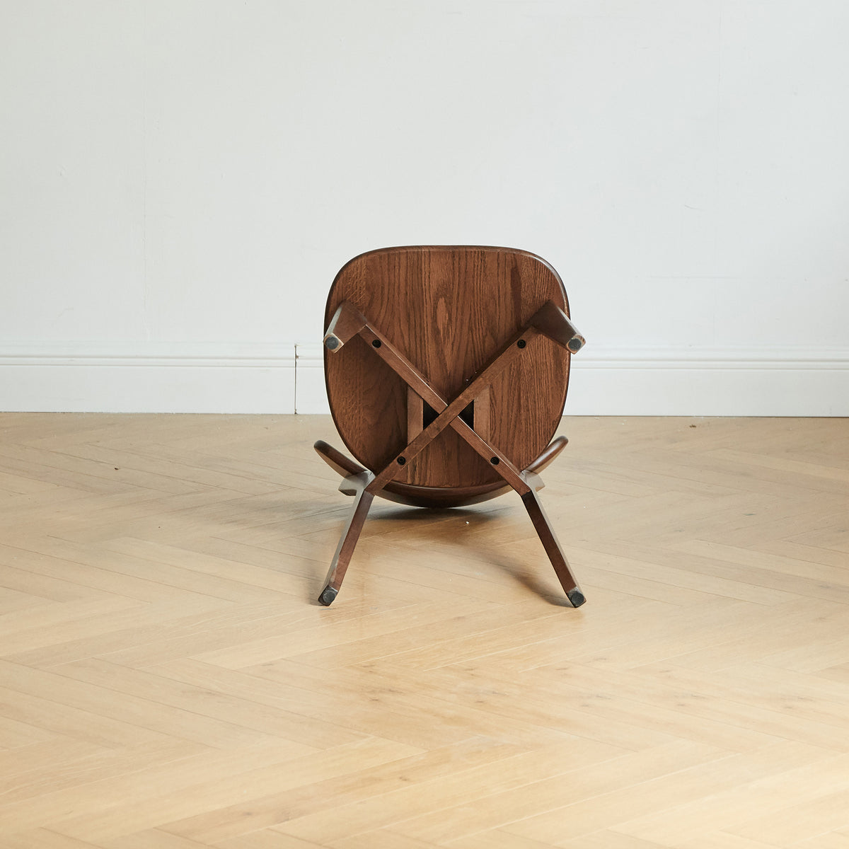 Mogan walnut dining chair underside view showing the solid wood seat and frame construction