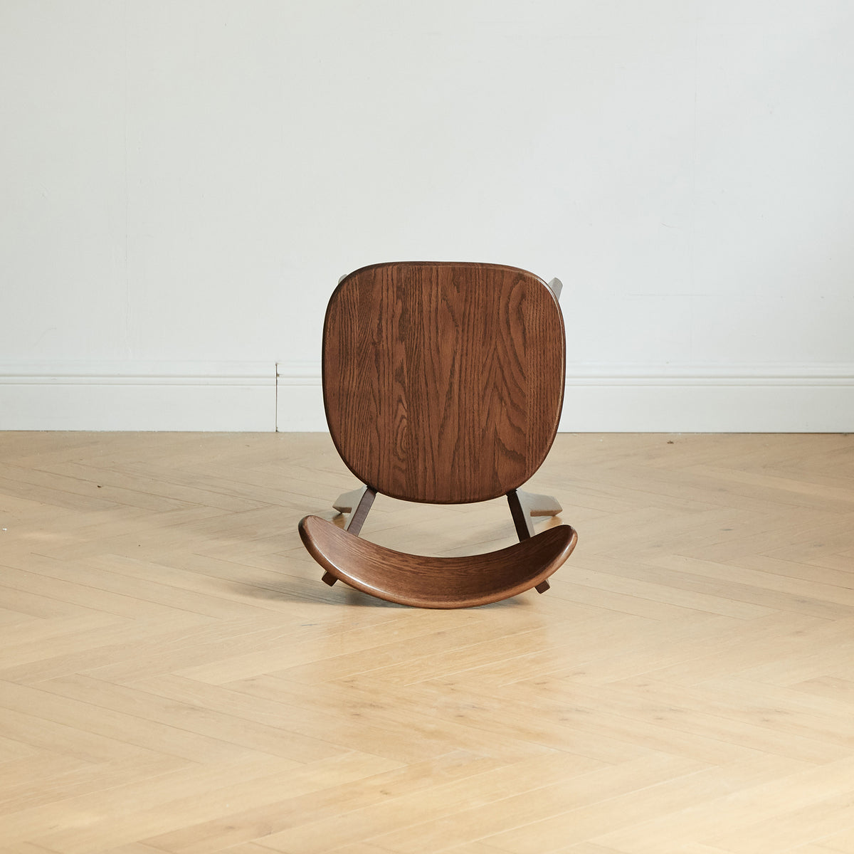 Mogan walnut solid wood dining chair underside view showing the contoured seat and frame connection