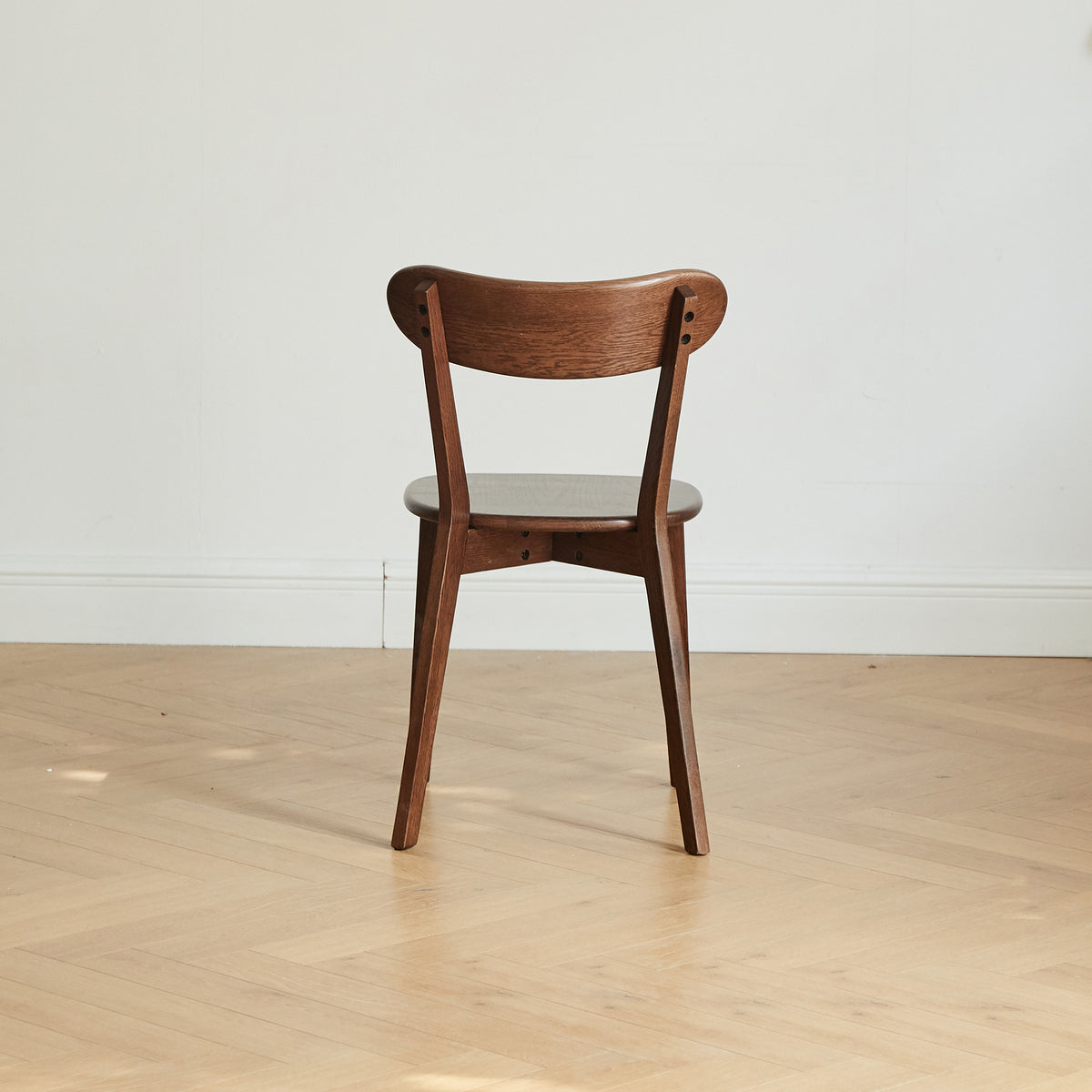 Mogan walnut solid wood dining chair rear view showing curved backrest on white background
