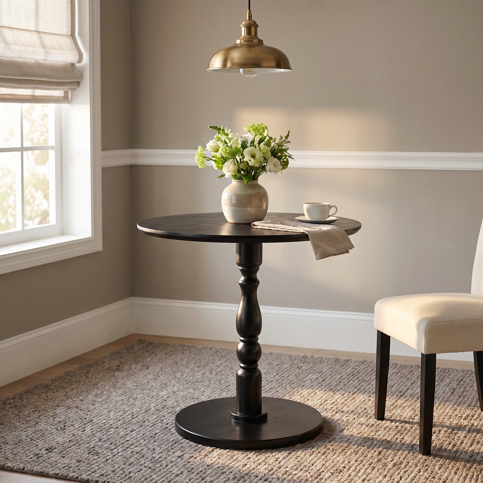Monaco black side table showing a styled round table with chairs in a dining nook