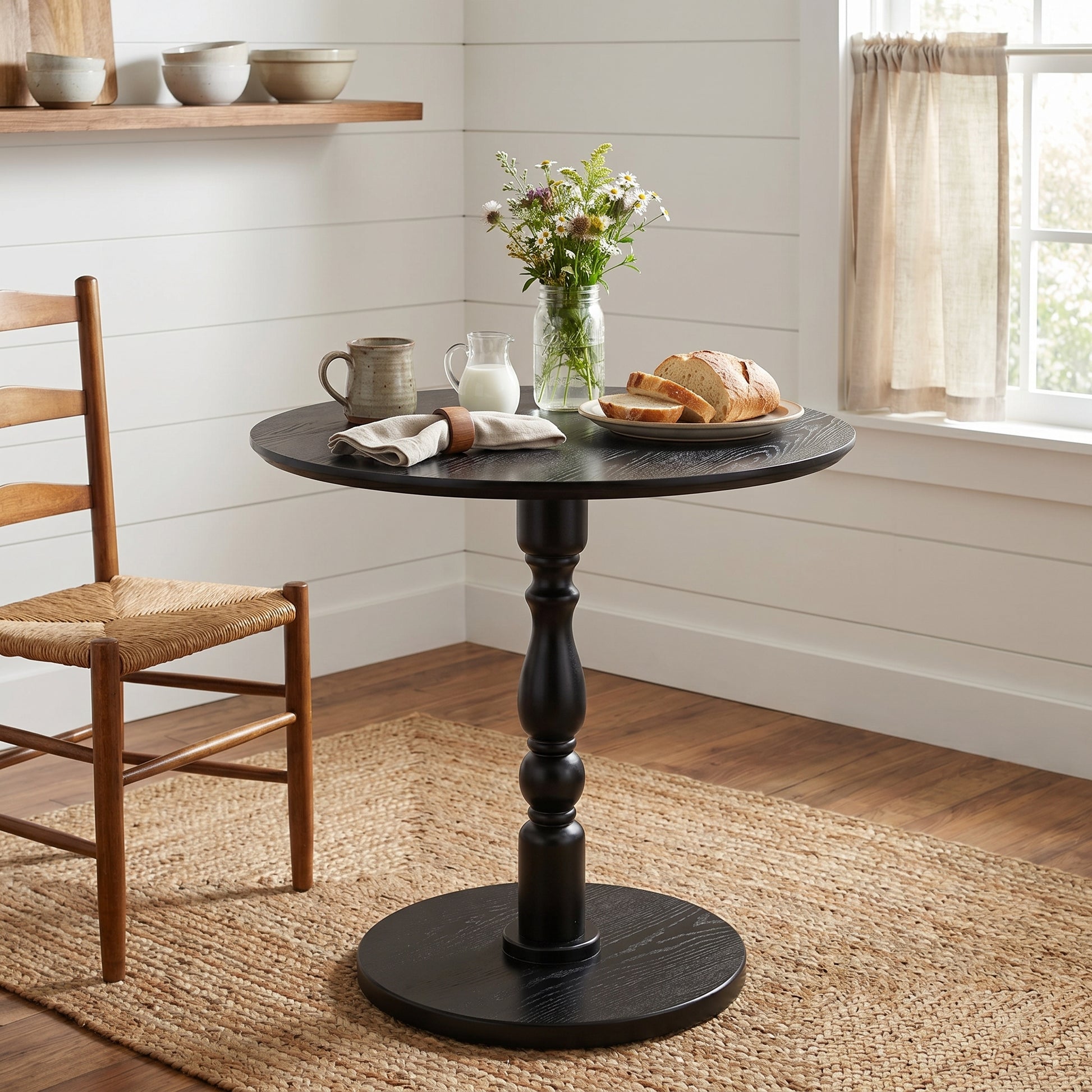 Monaco black side table showing a compact round table in a modern dining space