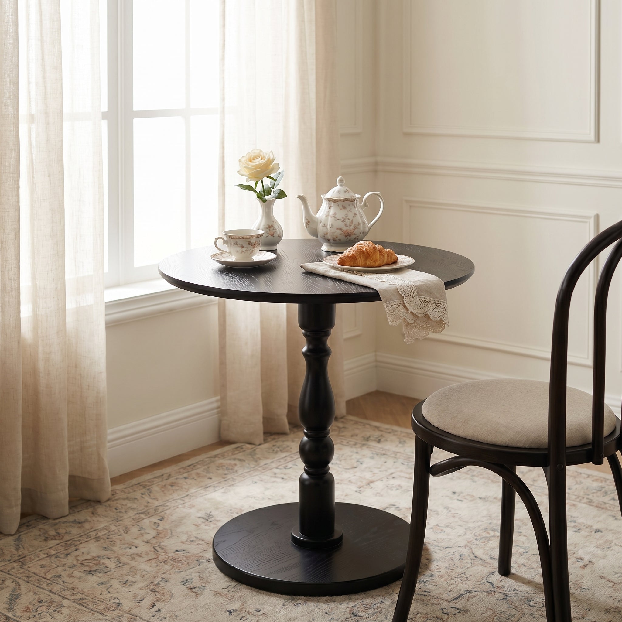 Monaco black side table showing a compact round table in a modern dining space