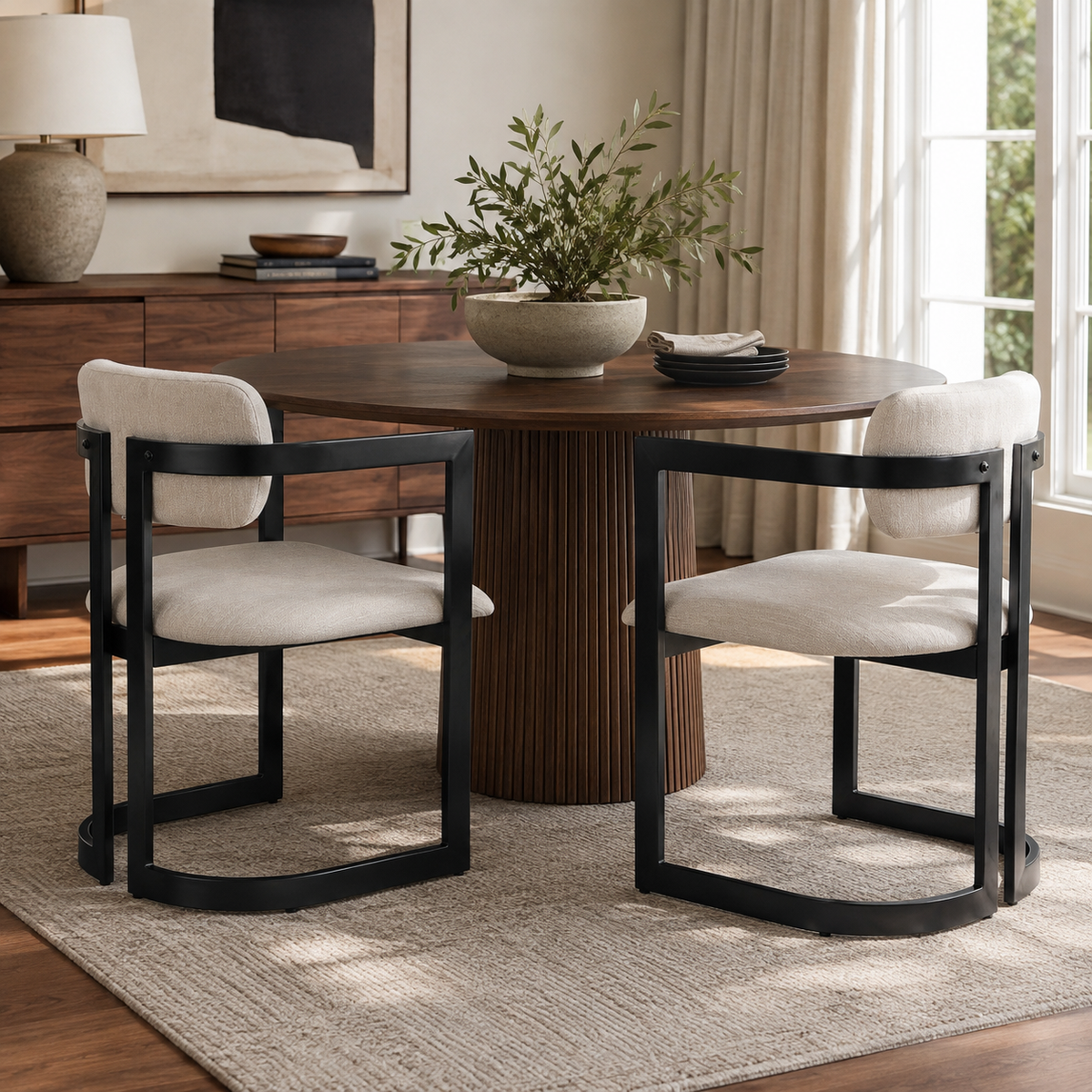 Morava black upholstered metal dining armchairs placed around a dining table in a bright dining area