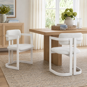Morava white upholstered metal dining armchairs styled with a round wood dining table in a bright dining room