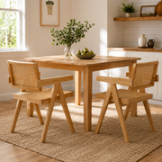 Mosel natural woven rattan dining chairs with solid rubberwood frames around a wood dining table