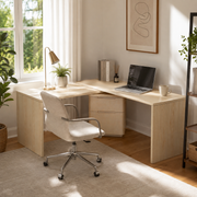 Narvik natural executive desk showing an L-shaped workspace with a laptop beside a bright window