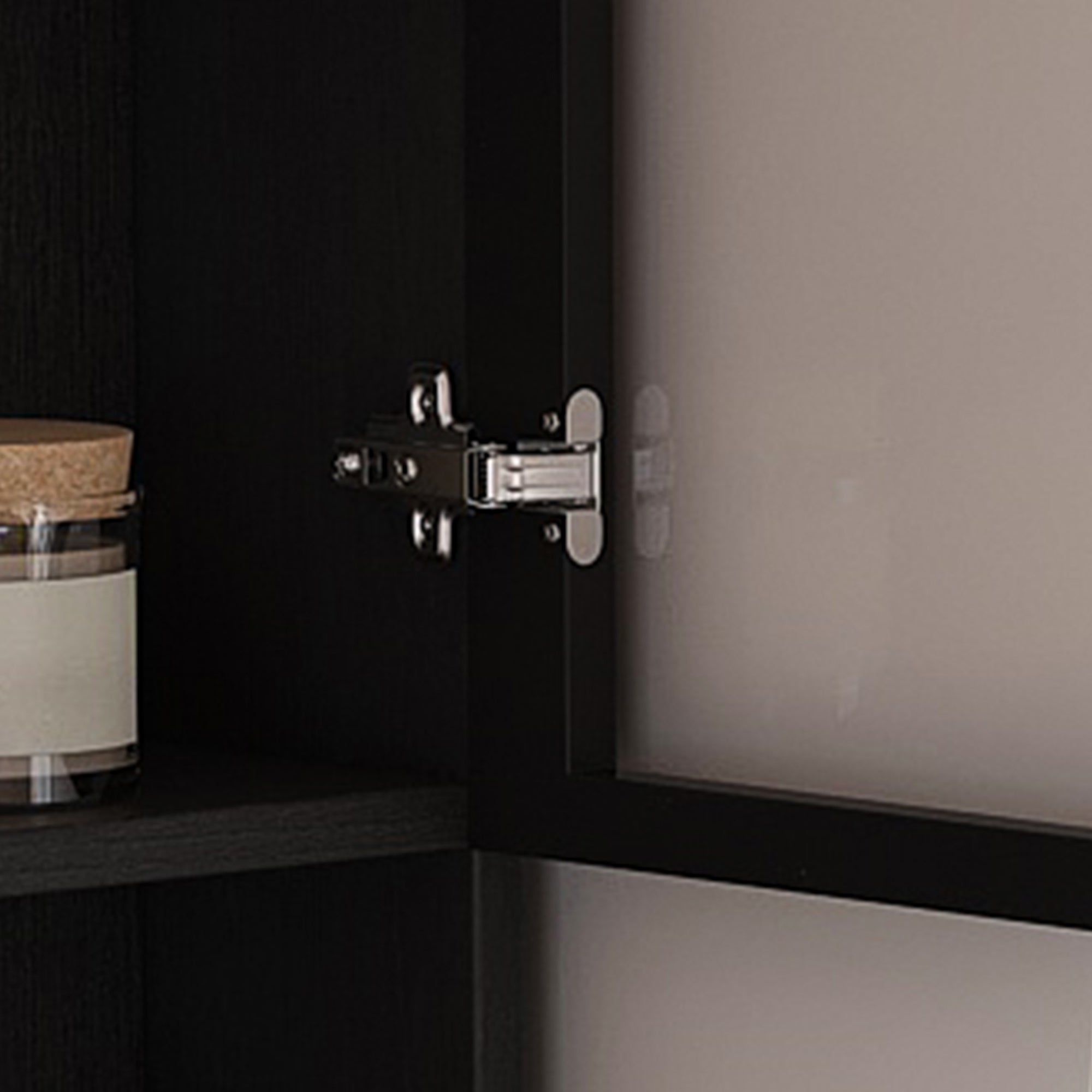 Nord black computer desk showing glass cabinet hinge and interior storage detail