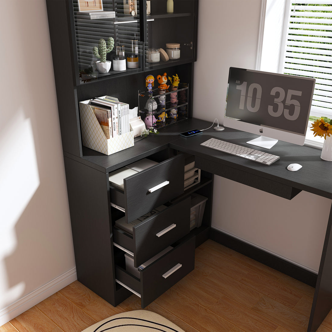 Nord black computer desk showing three storage drawers and L-shaped workspace detail