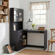 Nord black computer desk showing an L-shaped desk with glass cabinets in a bright home office