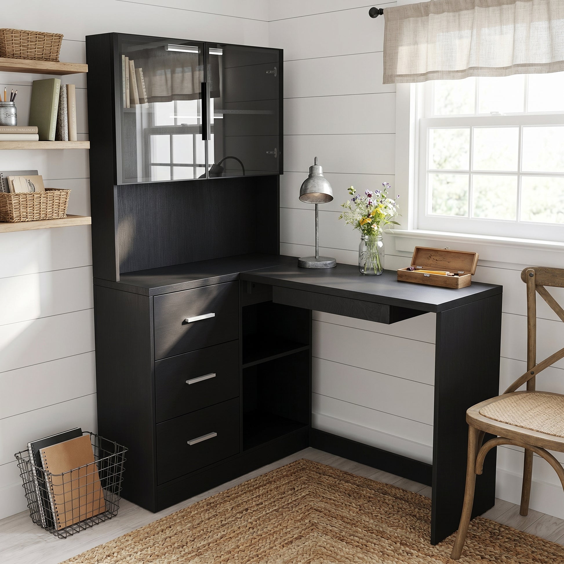 Nord black computer desk showing an L-shaped office setup with books shelves and display cabinet