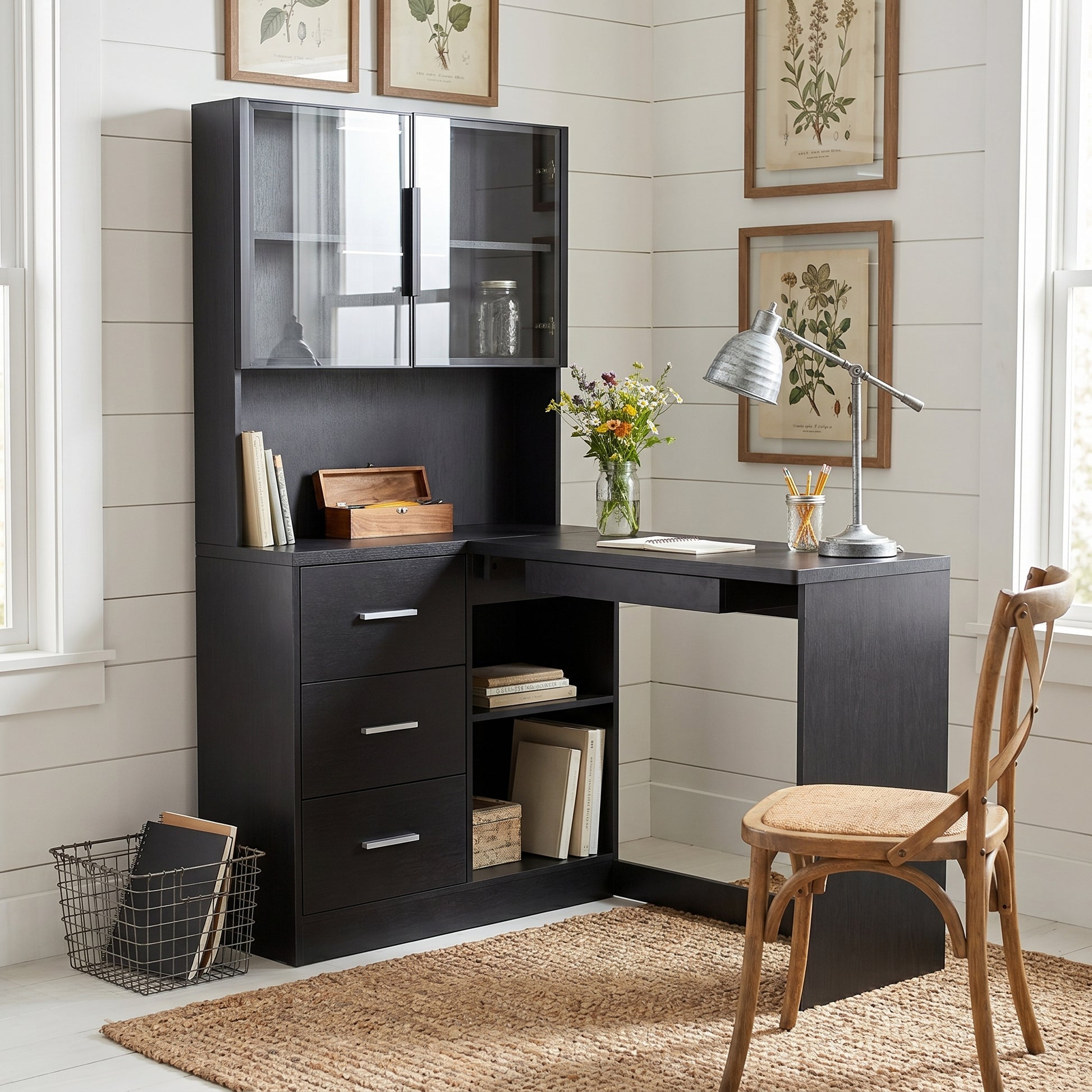 Nord black computer desk showing a workspace with monitor shelf drawers and glass-door storage