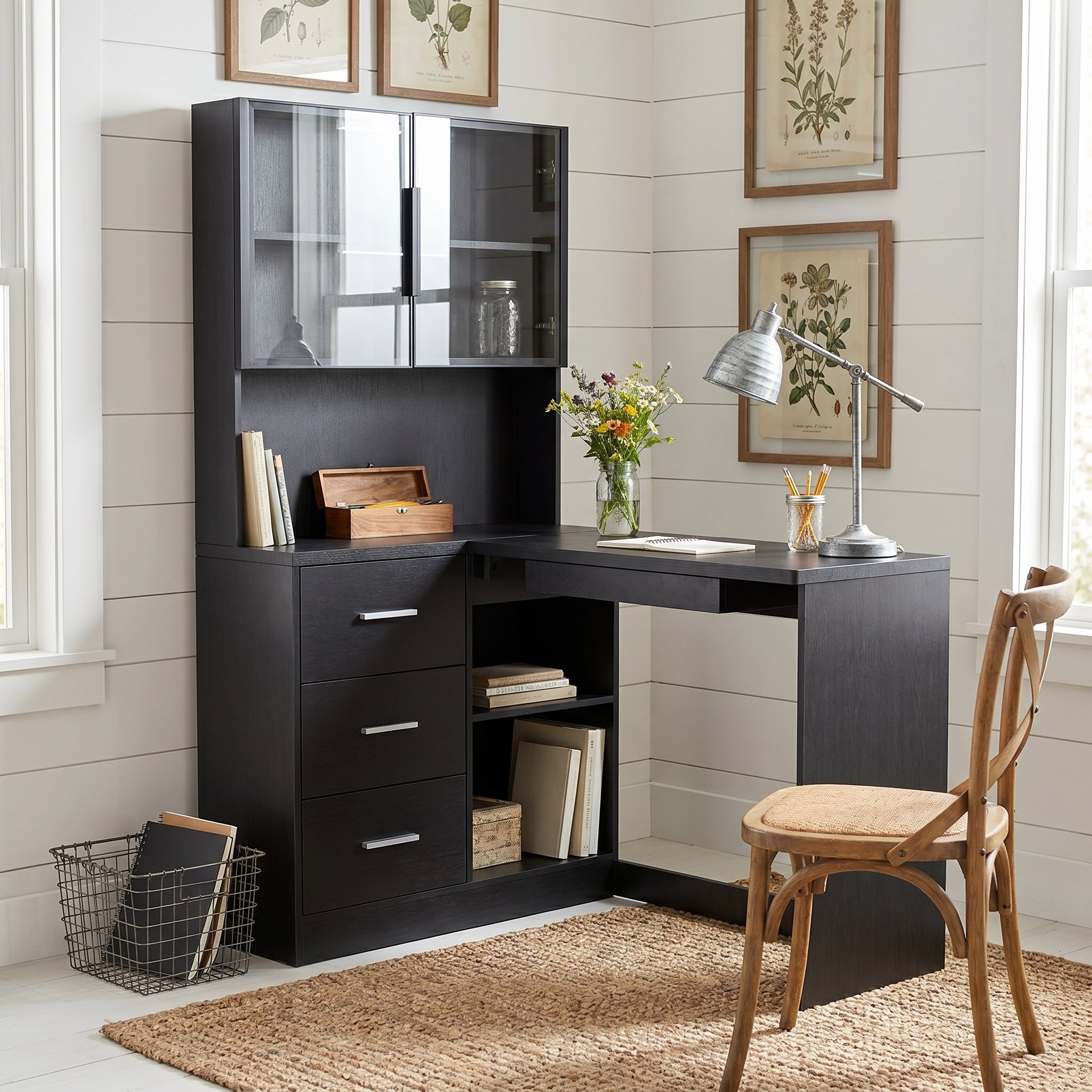Nord black computer desk showing a workspace with monitor shelf drawers and glass-door storage