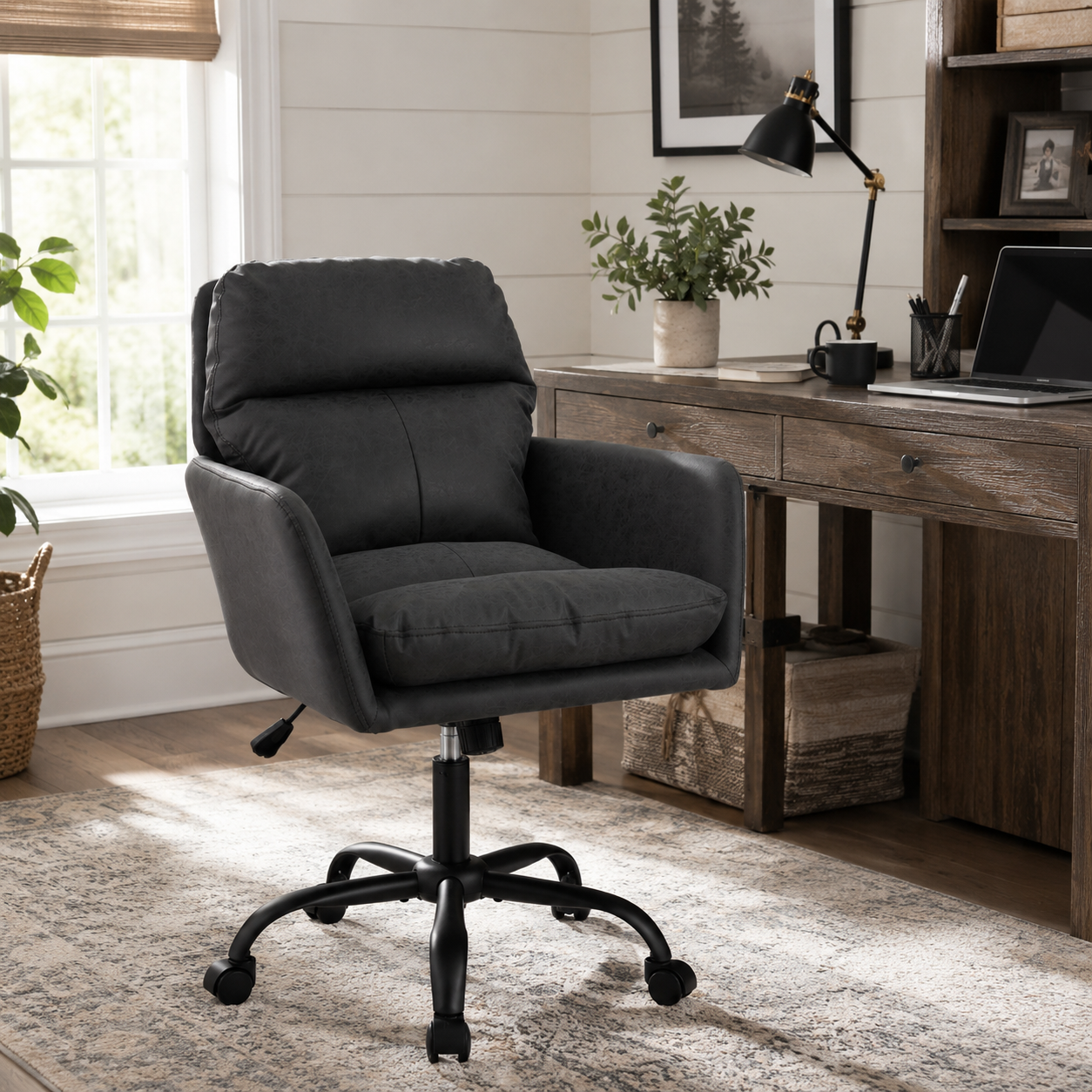 Norven black padded arm office chair in a cozy workspace with dark wood furniture