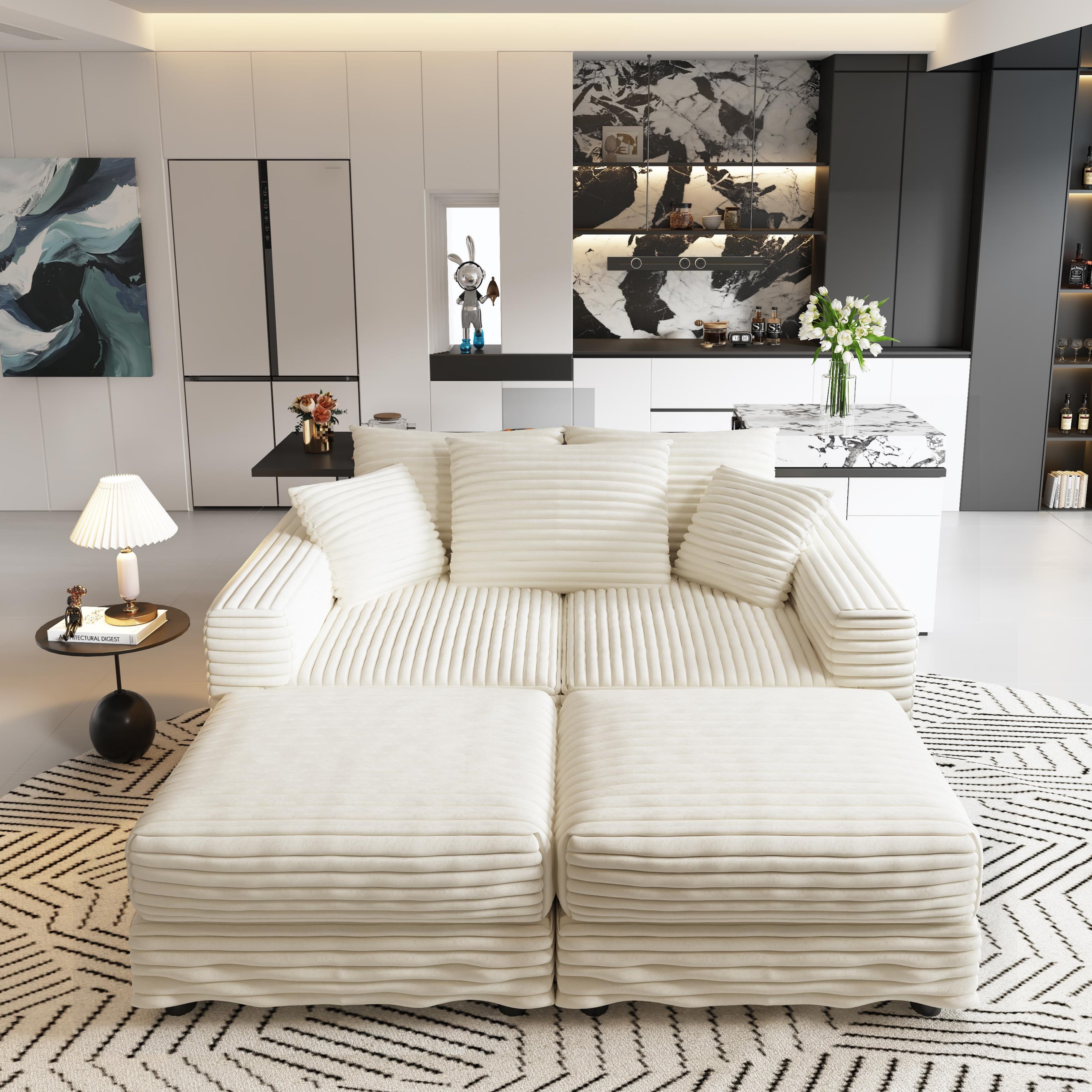  Beige sectional sofa with two ottomans arranged as extended chaise lounge