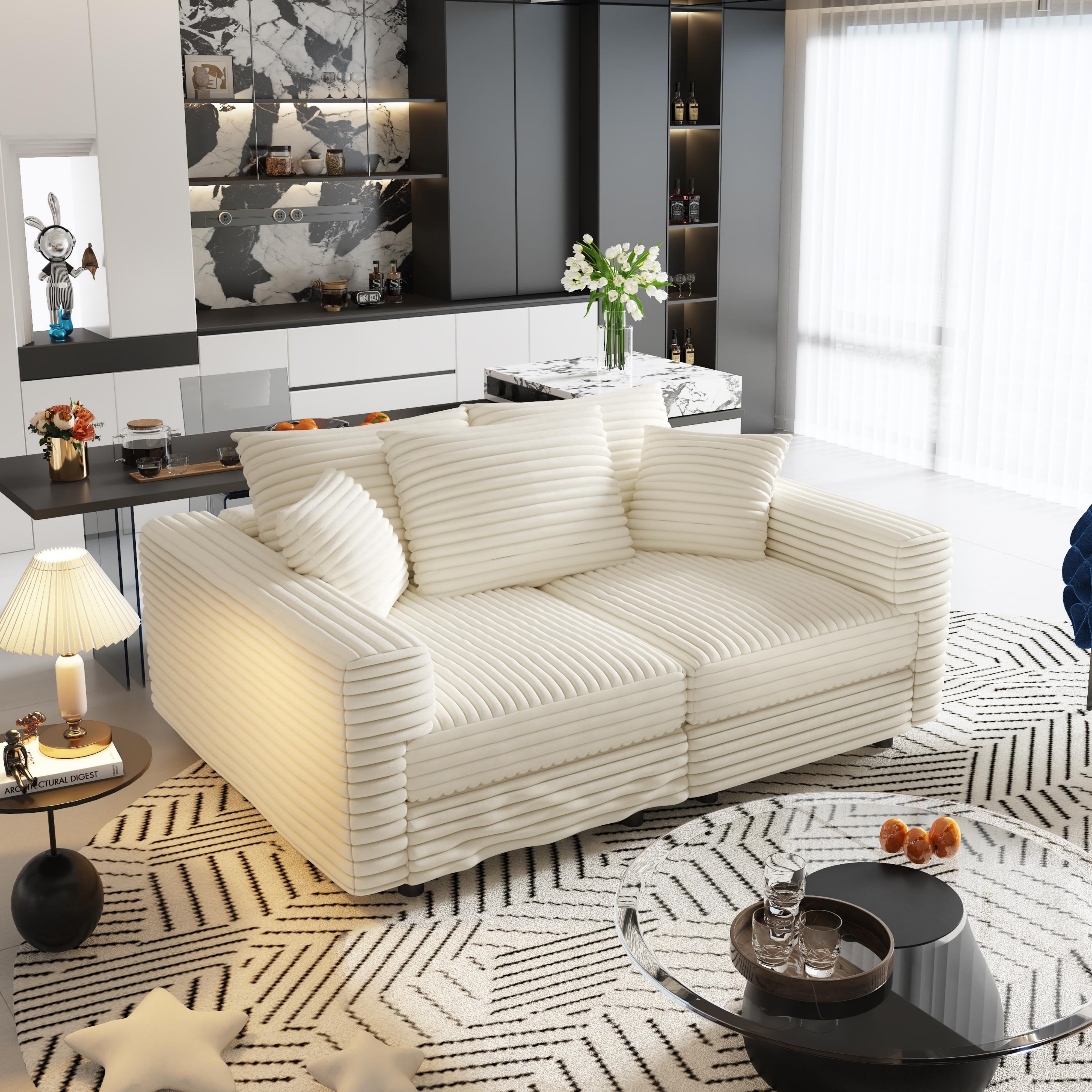 Norwalk beige sofa with ottoman showing angled view in contemporary living space