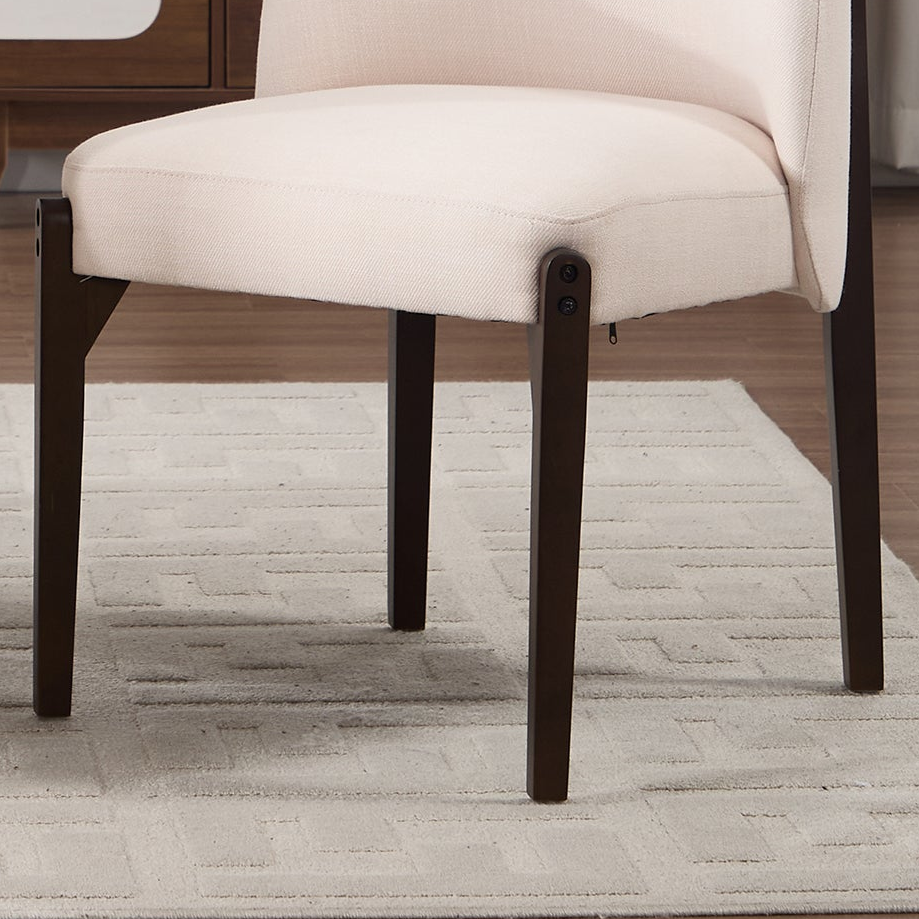 Orta beige dining chair close-up of the curved upholstered barrel backrest