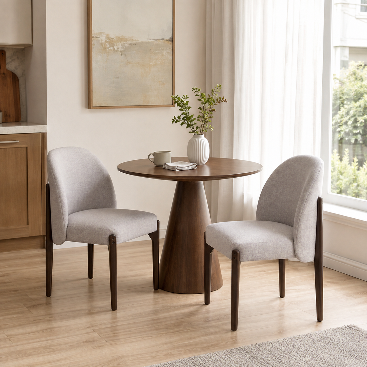 Orta gray dining chairs in a bright dining room with natural wood furniture and plants