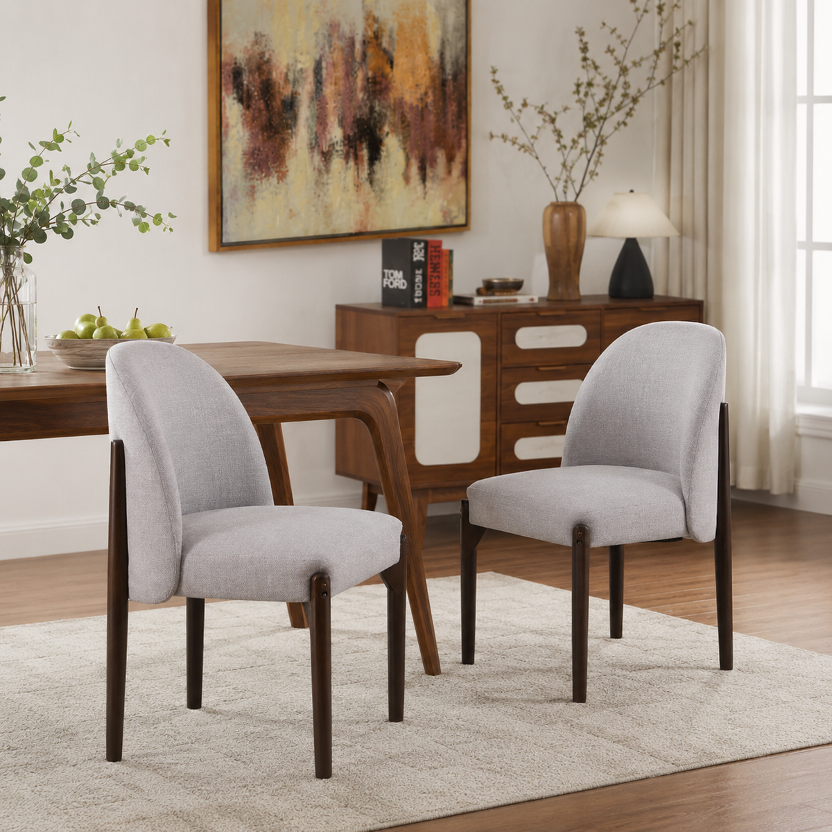 Orta gray upholstered dining chairs around a wood table in a warm modern dining space