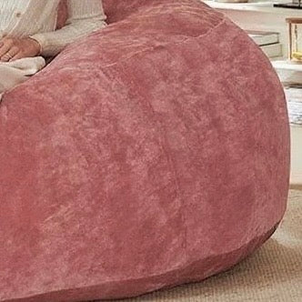 Pebble pink bean bag chair showing textured upholstery surface detail