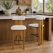 Pienza ivory upholstered bar stools beside a kitchen island