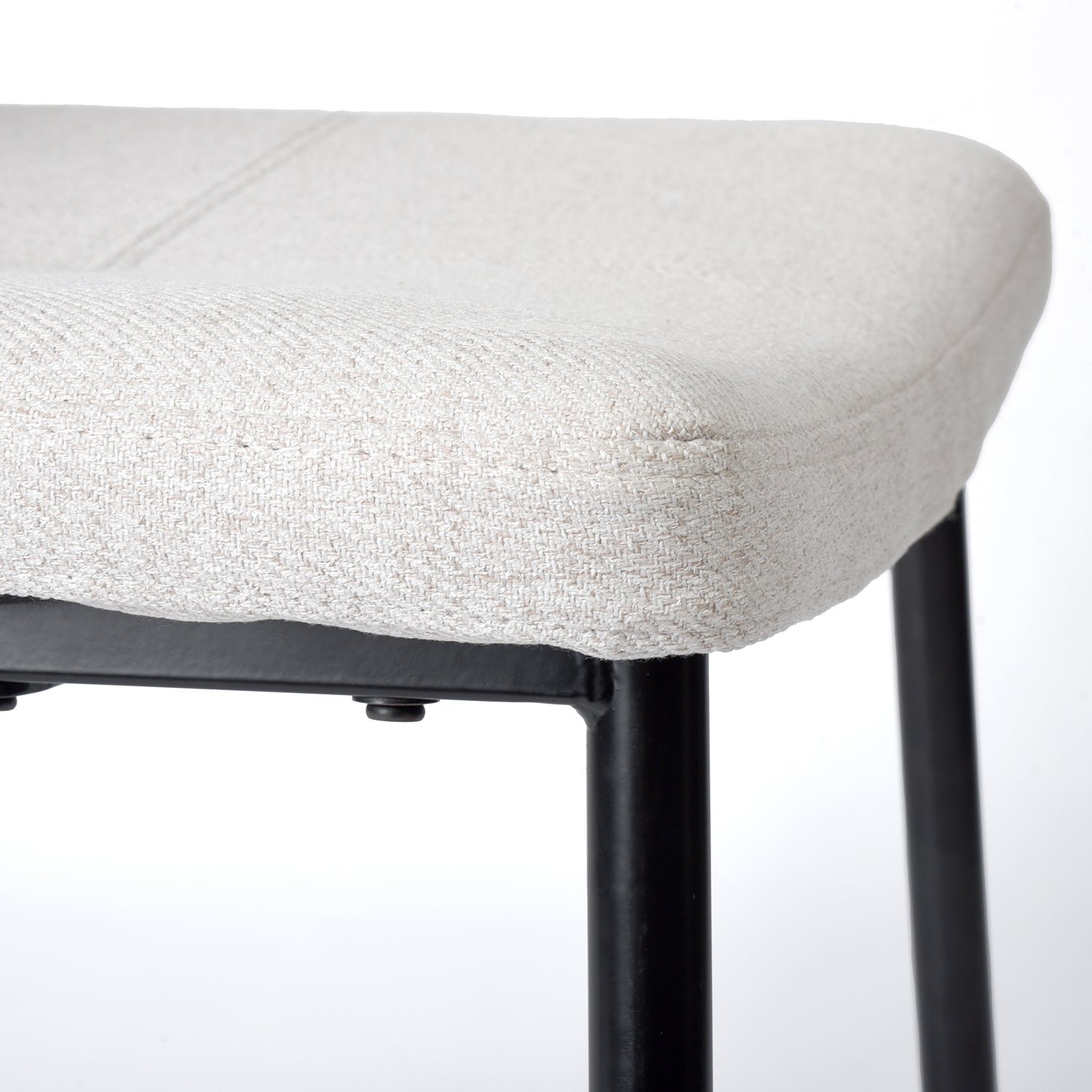 Pomona beige upholstered dining chair showing padded seat edge and metal leg detail