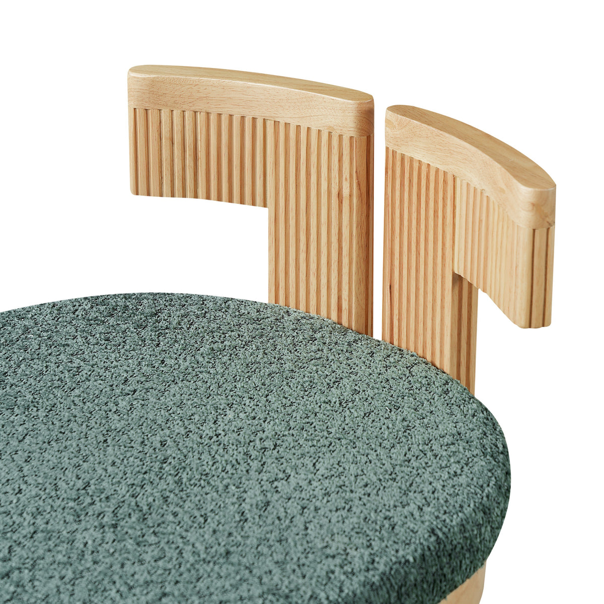 Pukaki green dining chair close-up of the loose boucle back cushion and fluted wood support