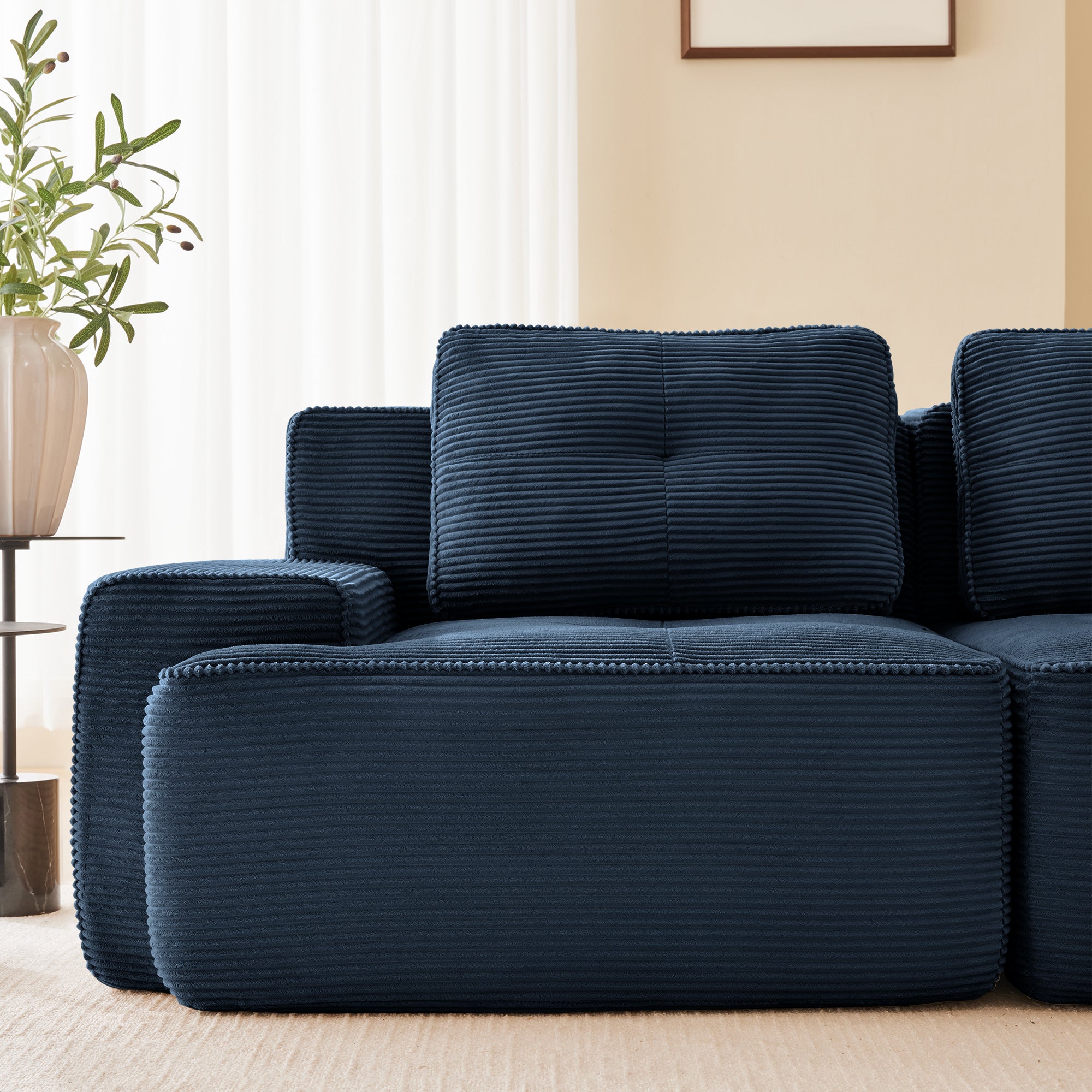 Racine blue loveseat sofa showing armrest and tufted cushion detail