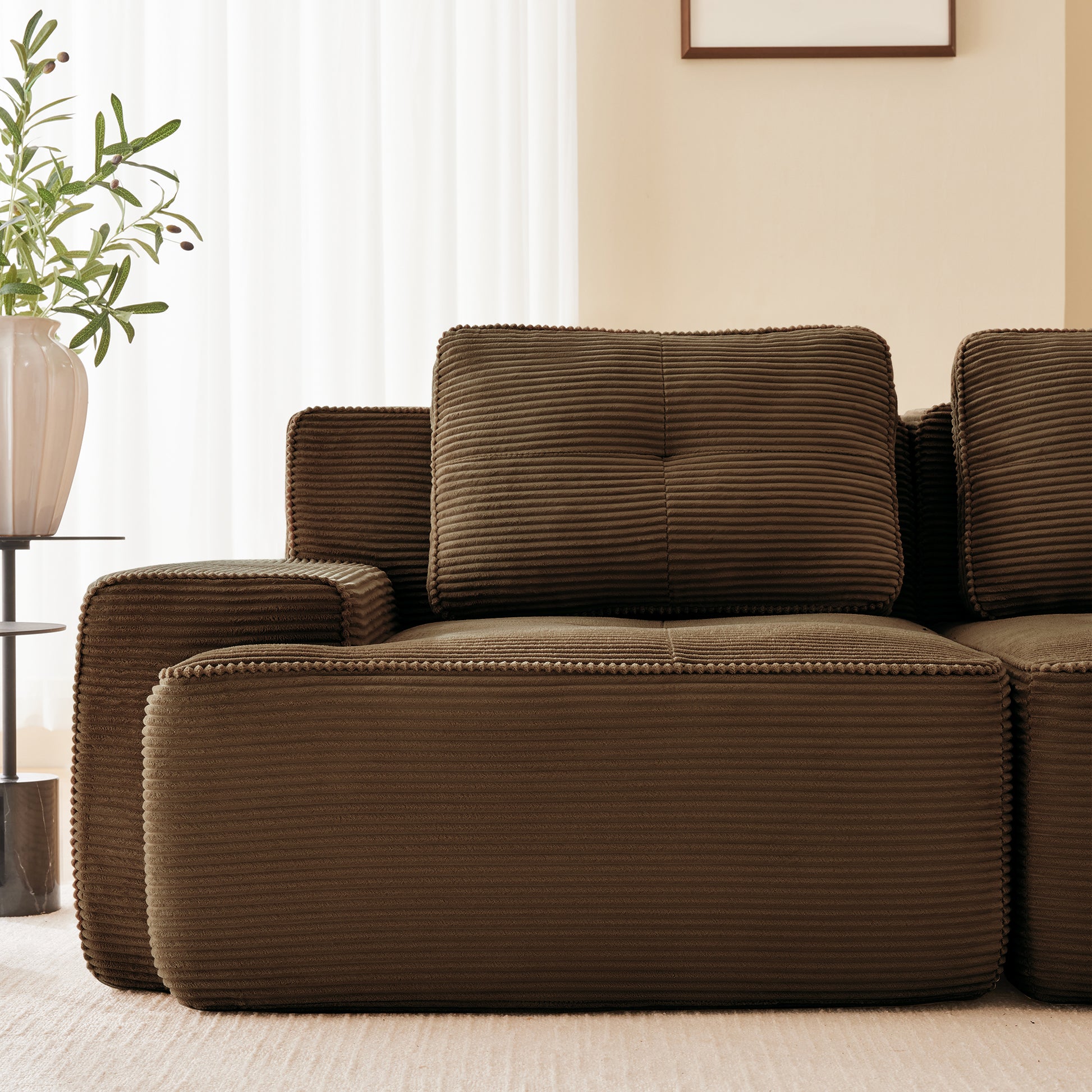 Racine brown modular sofa showing armrest cushion and pillow detail