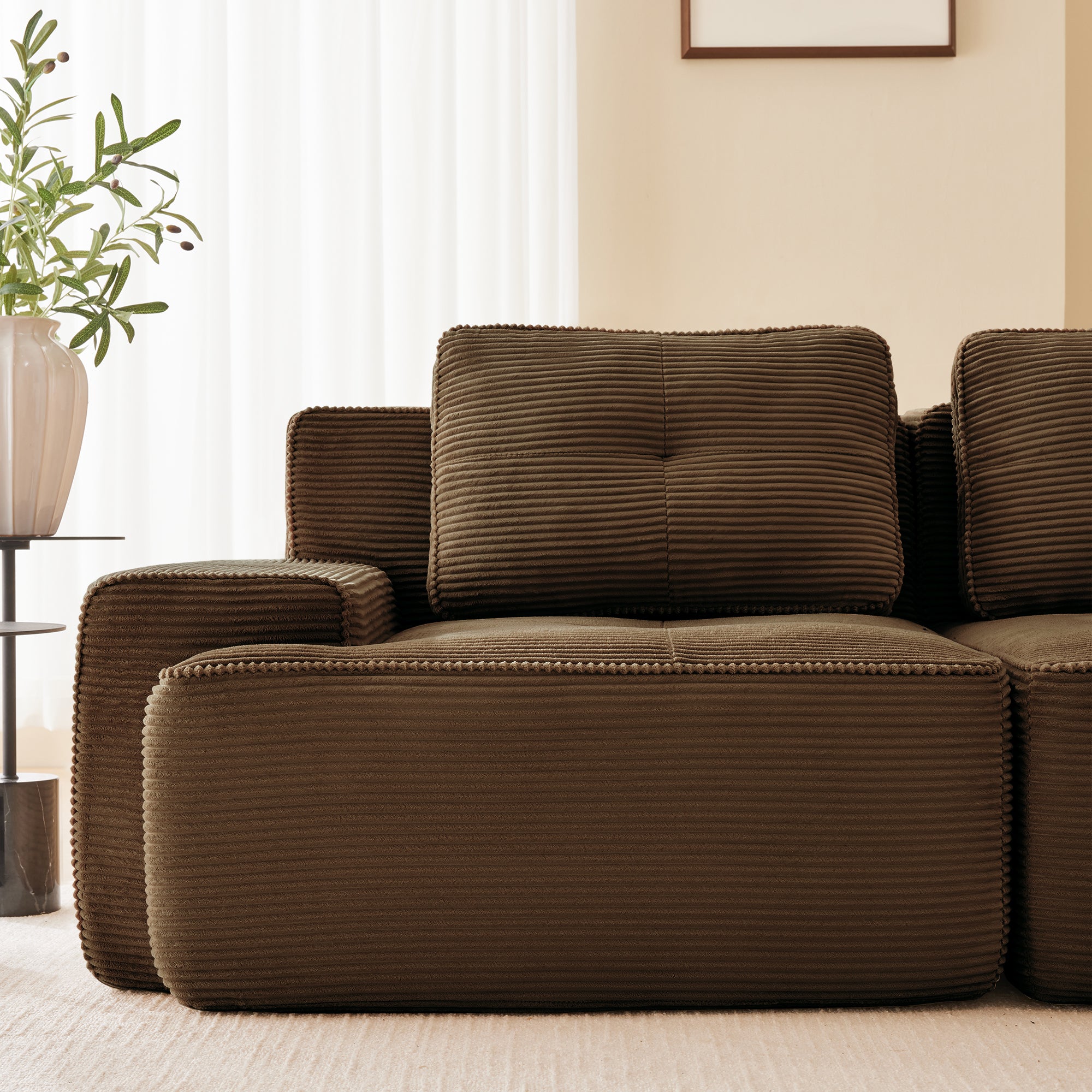 Racine brown modular sofa showing armrest cushion and pillow detail