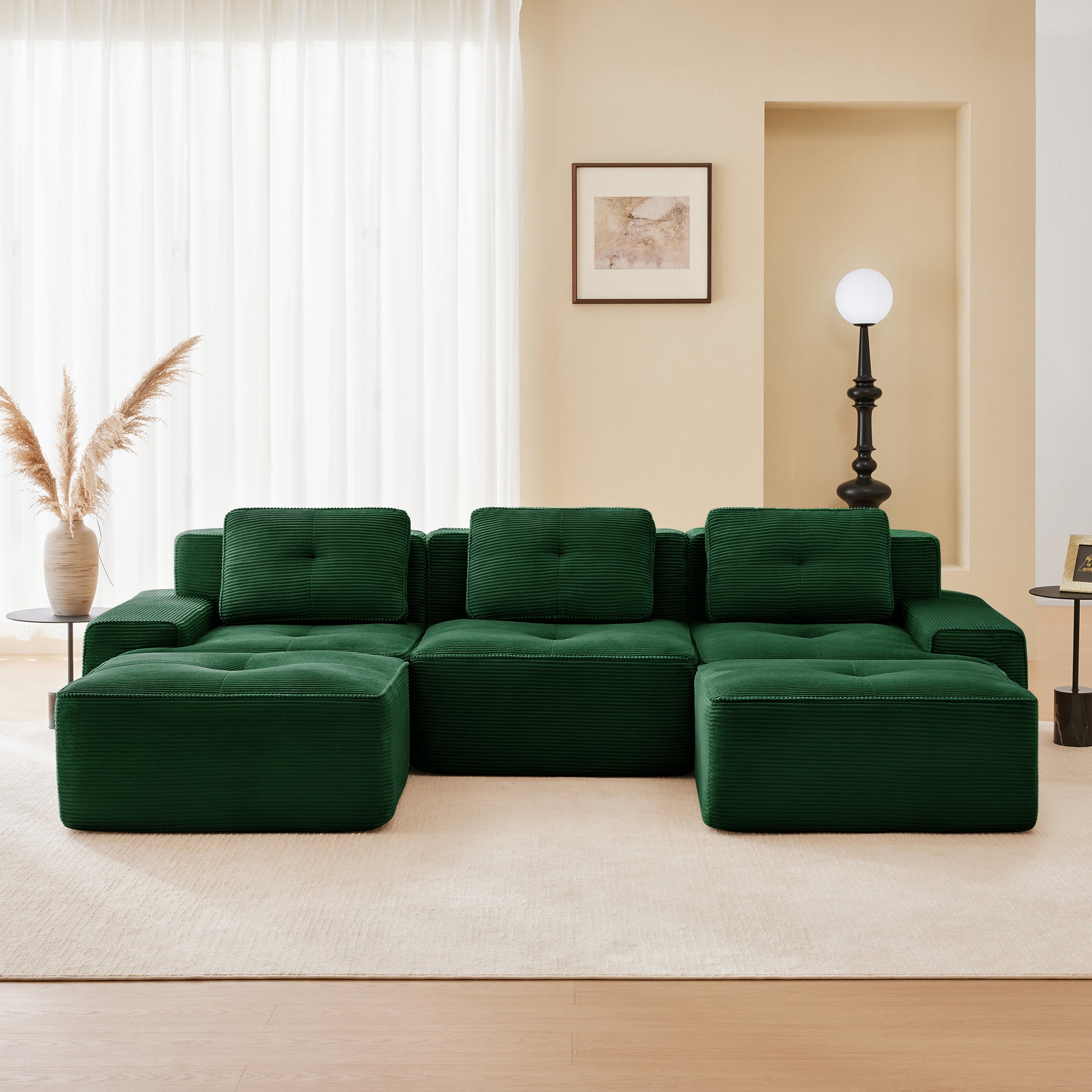 Racine green modular sofa showing front living room setup with two ottomans
