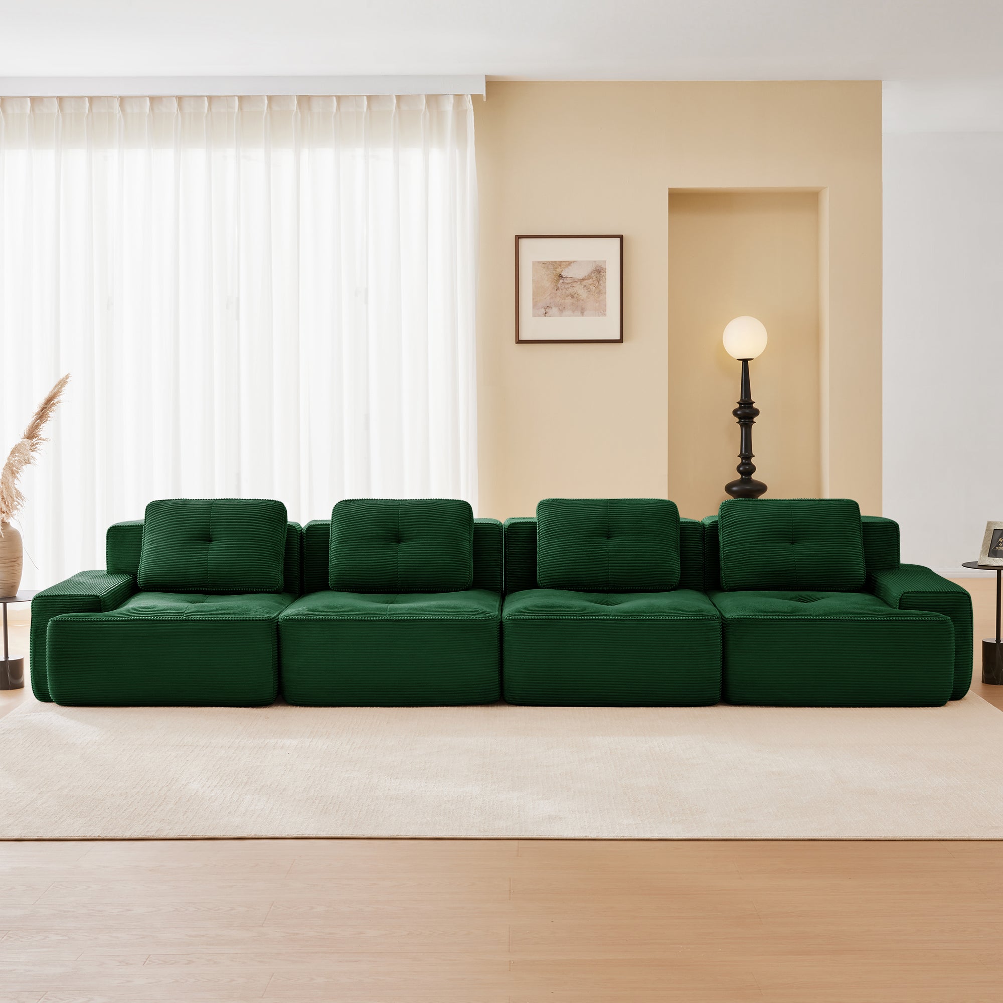 Racine green modular sofa showing front living room setup with two ottomans