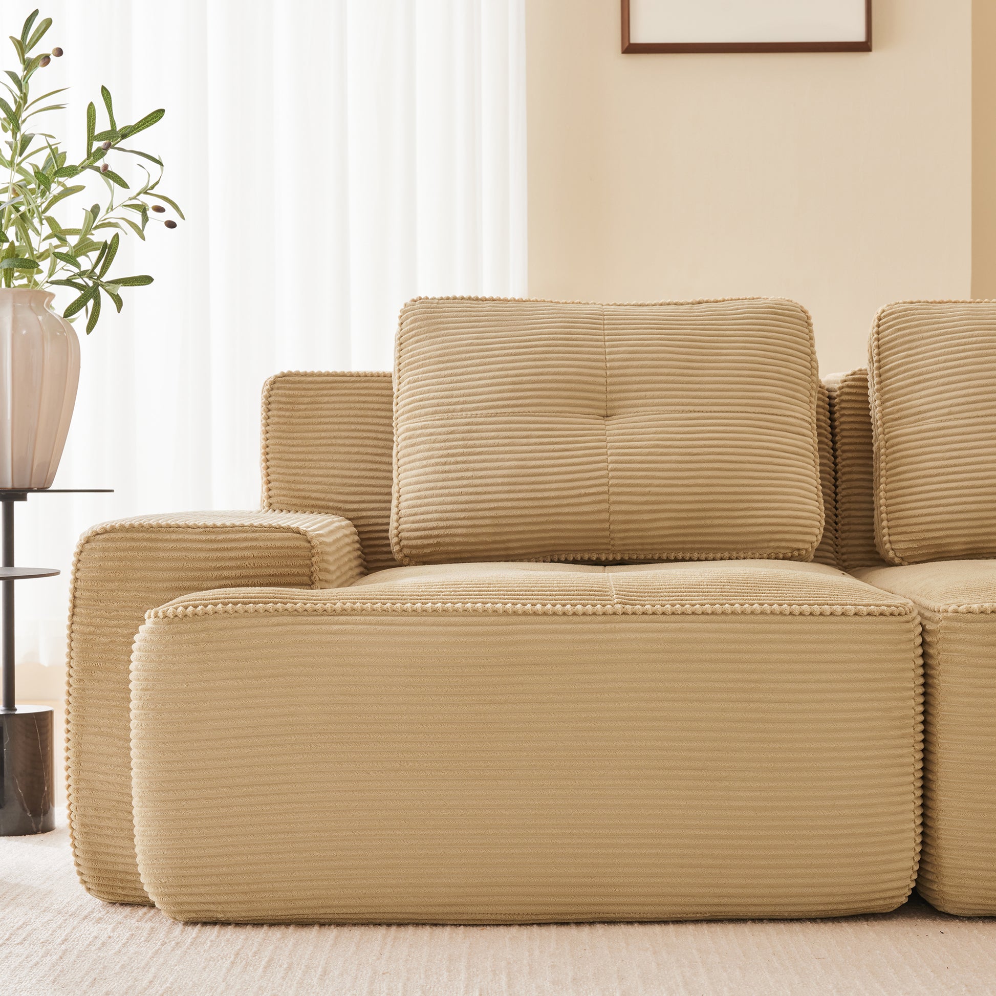 Racine light camel modular sofa showing pillow and armrest detail in room setting