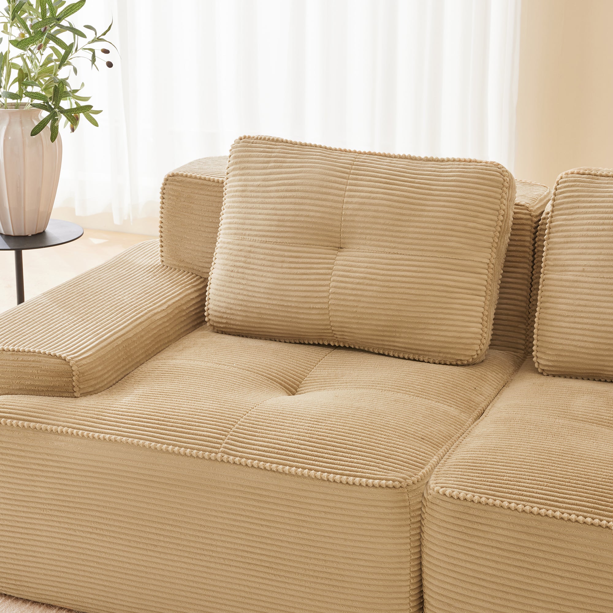 Racine light camel modular sofa showing pillow and armrest detail in room setting