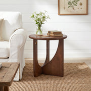 Ravon walnut end table showing angled front view beside a sofa