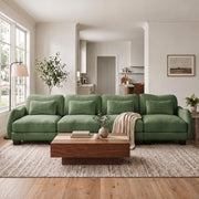 Rosedale green modular sofa shown in a bright living room with a wood coffee table and large windows