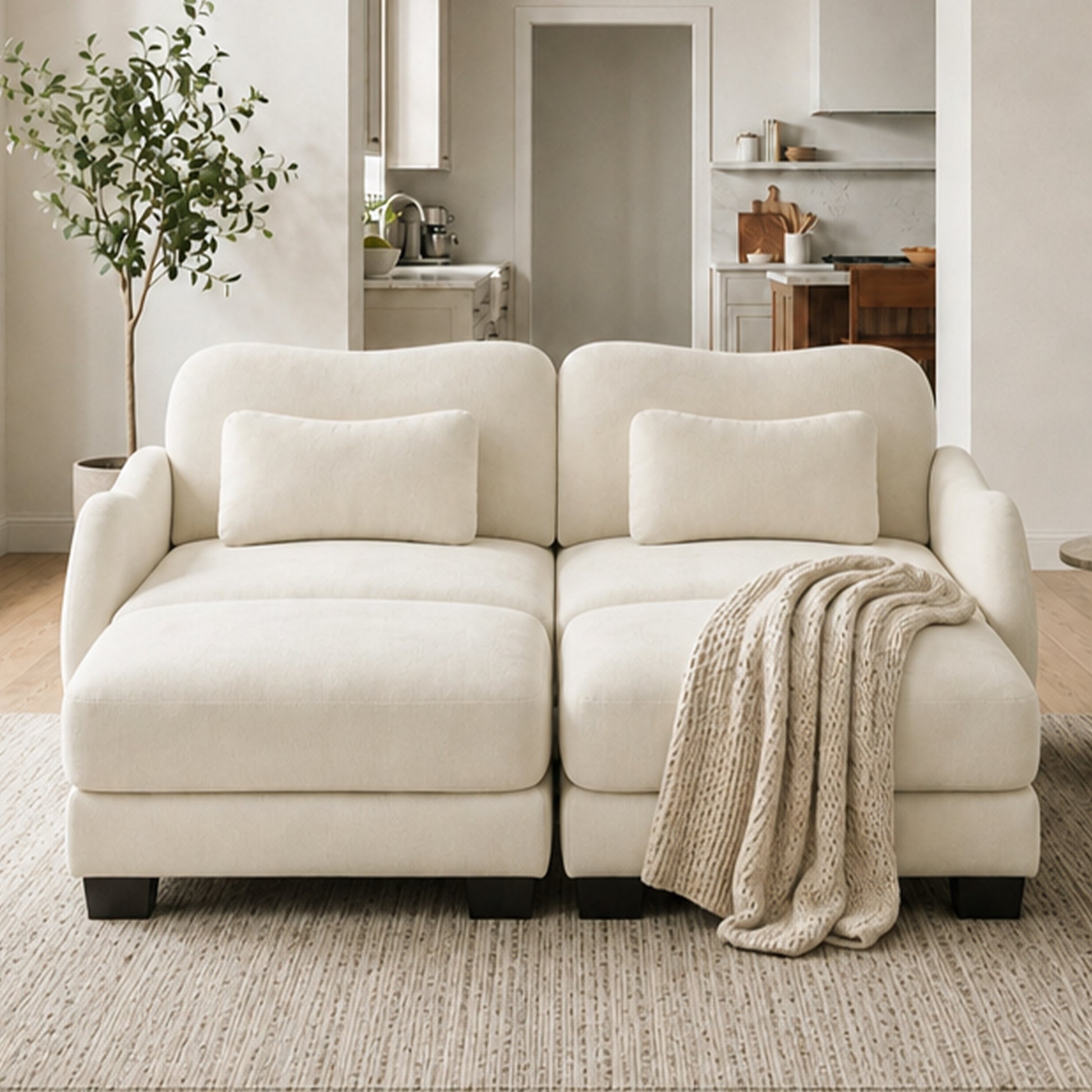 Rosedale beige sectional sofa showing a four-piece modular layout with two ottomans in a bright living room