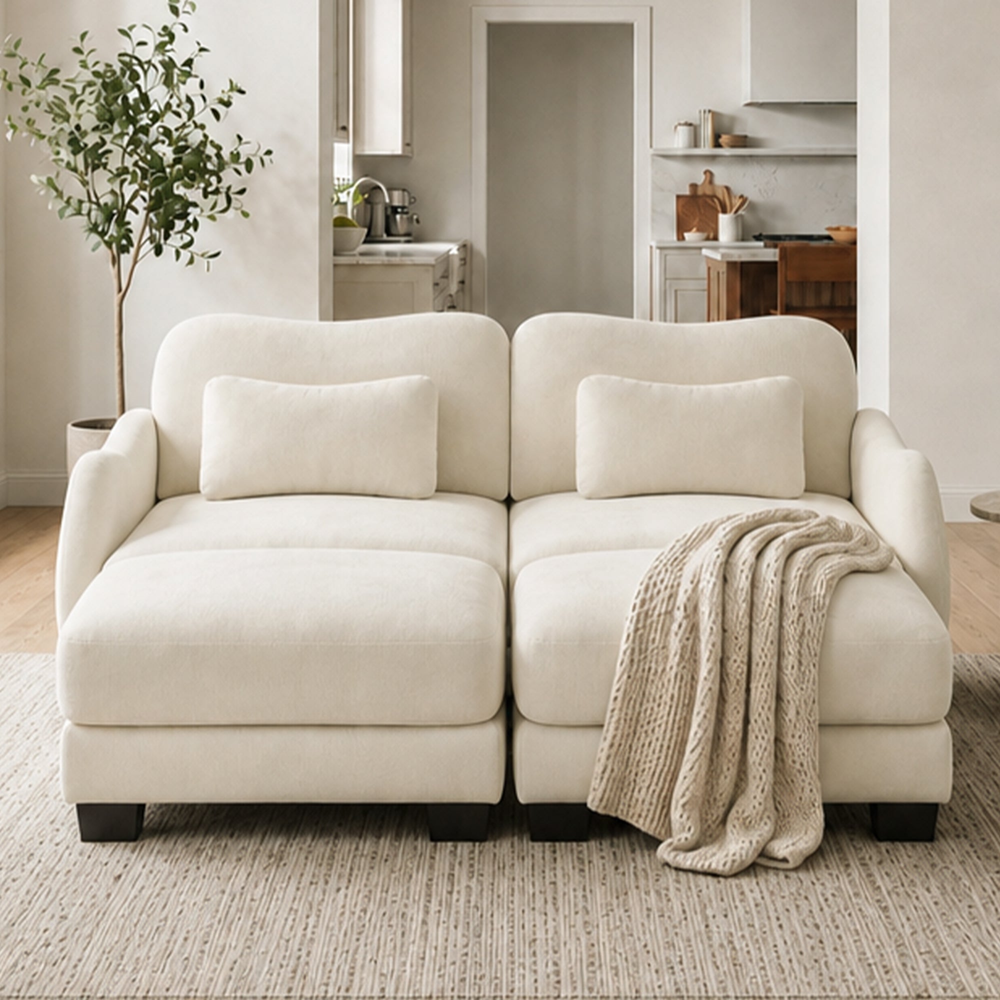 Rosedale beige sectional sofa showing a four-piece modular layout with two ottomans in a bright living room