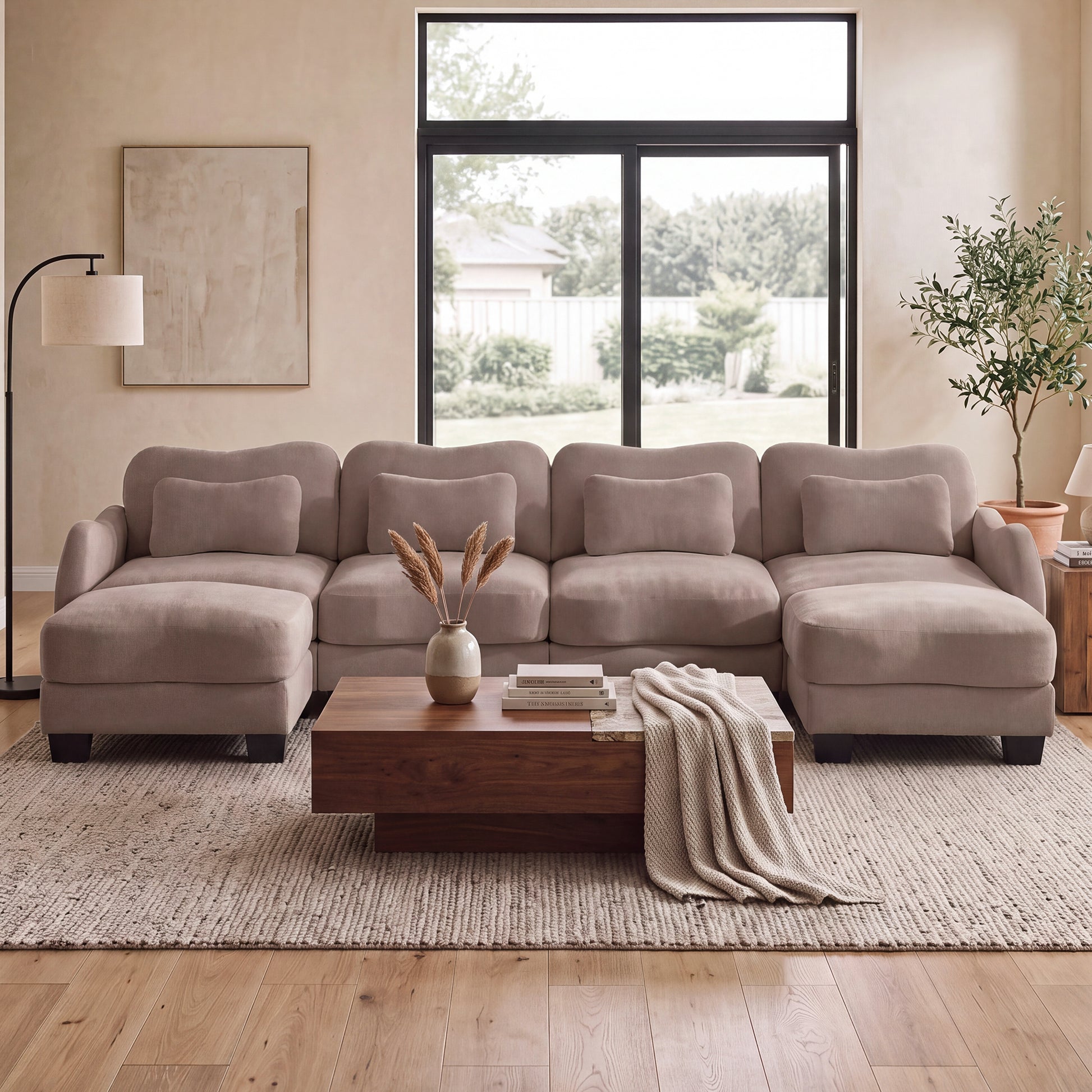 Rosedale brown gray sectional sofa shown in a bright living room with a wood coffee table and large windows