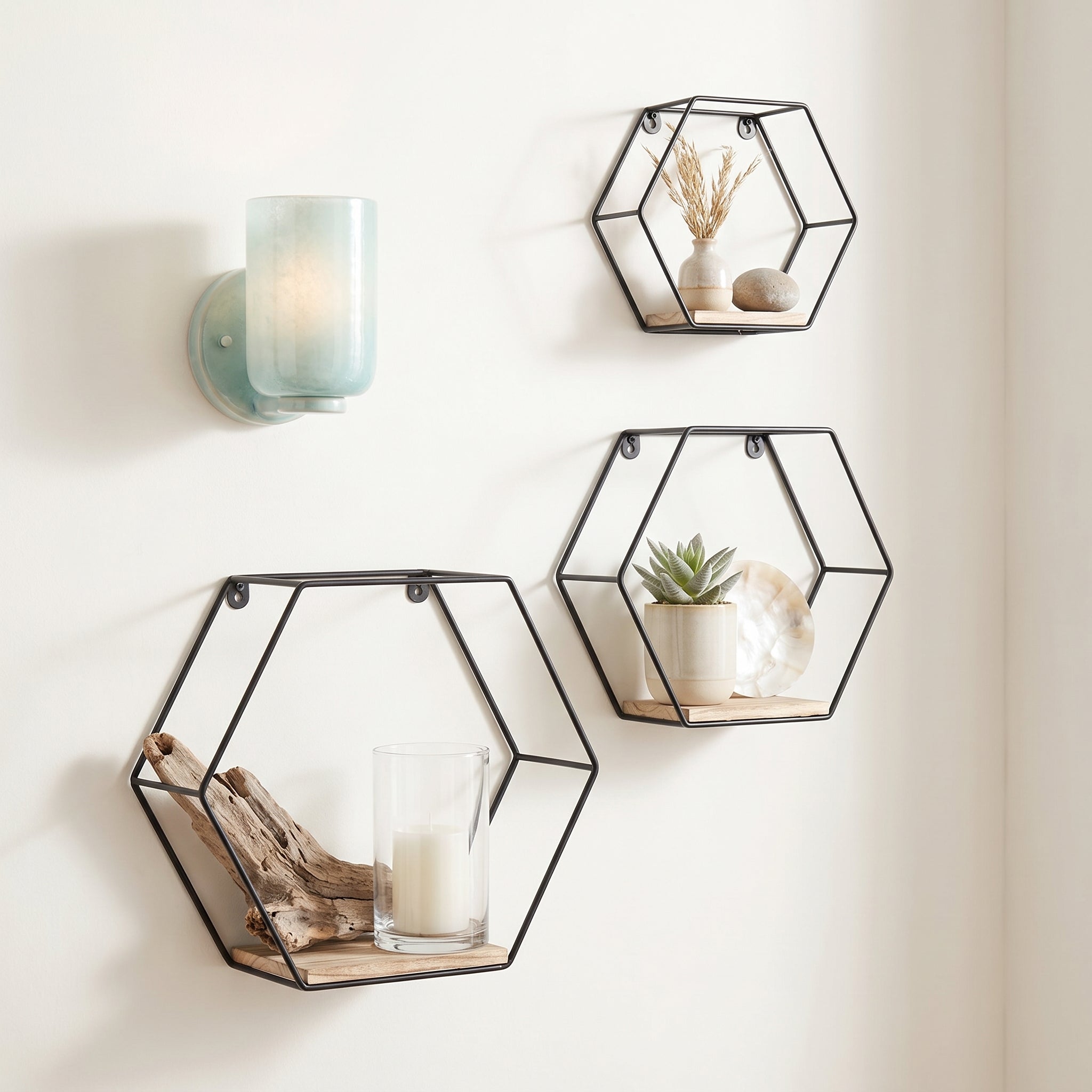 Sage natural floating shelves showing a geometric wall display in a bright interior