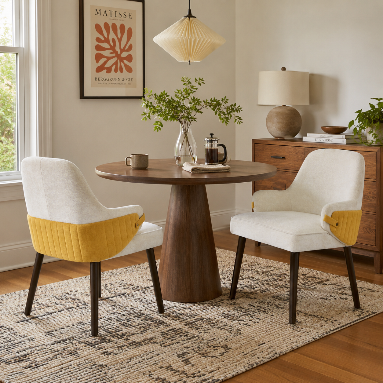 Saimaa yellow two-tone upholstered dining chairs around a round wood dining table in a bright dining room
