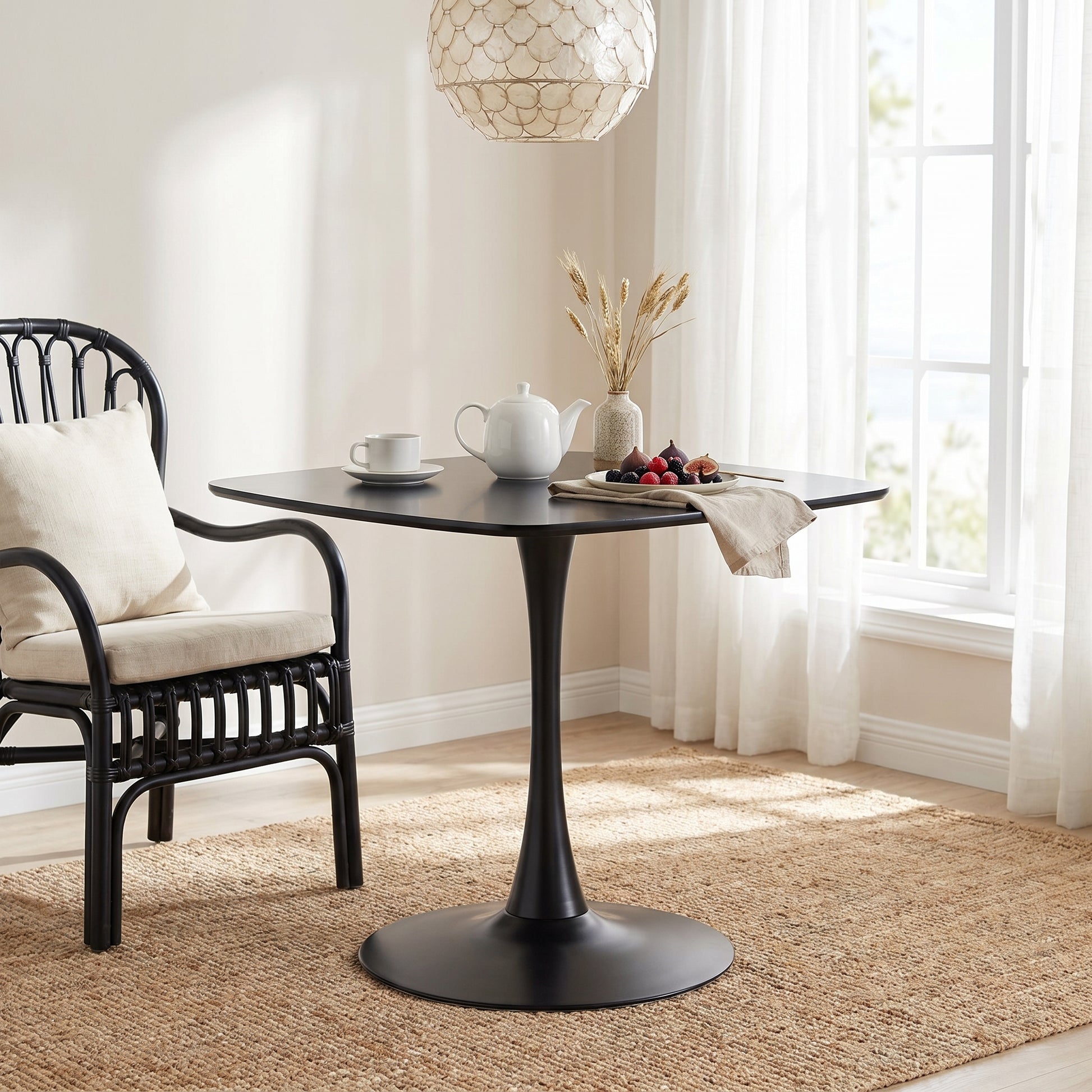Santorini black dining table showing a square table in a bright dining nook