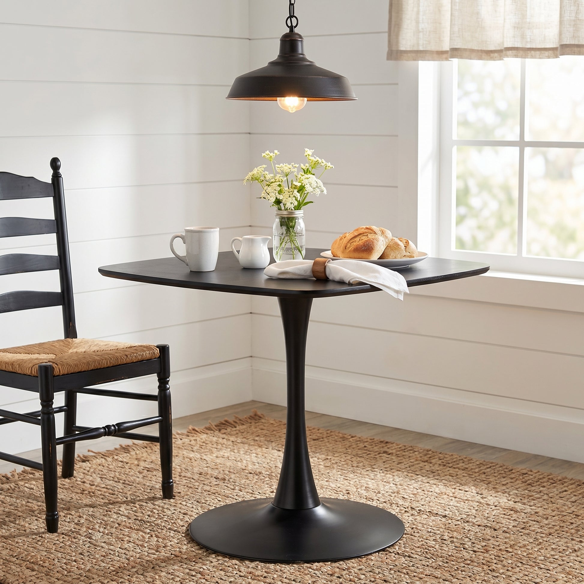 Santorini black dining table showing a styled dining area with mixed chairs