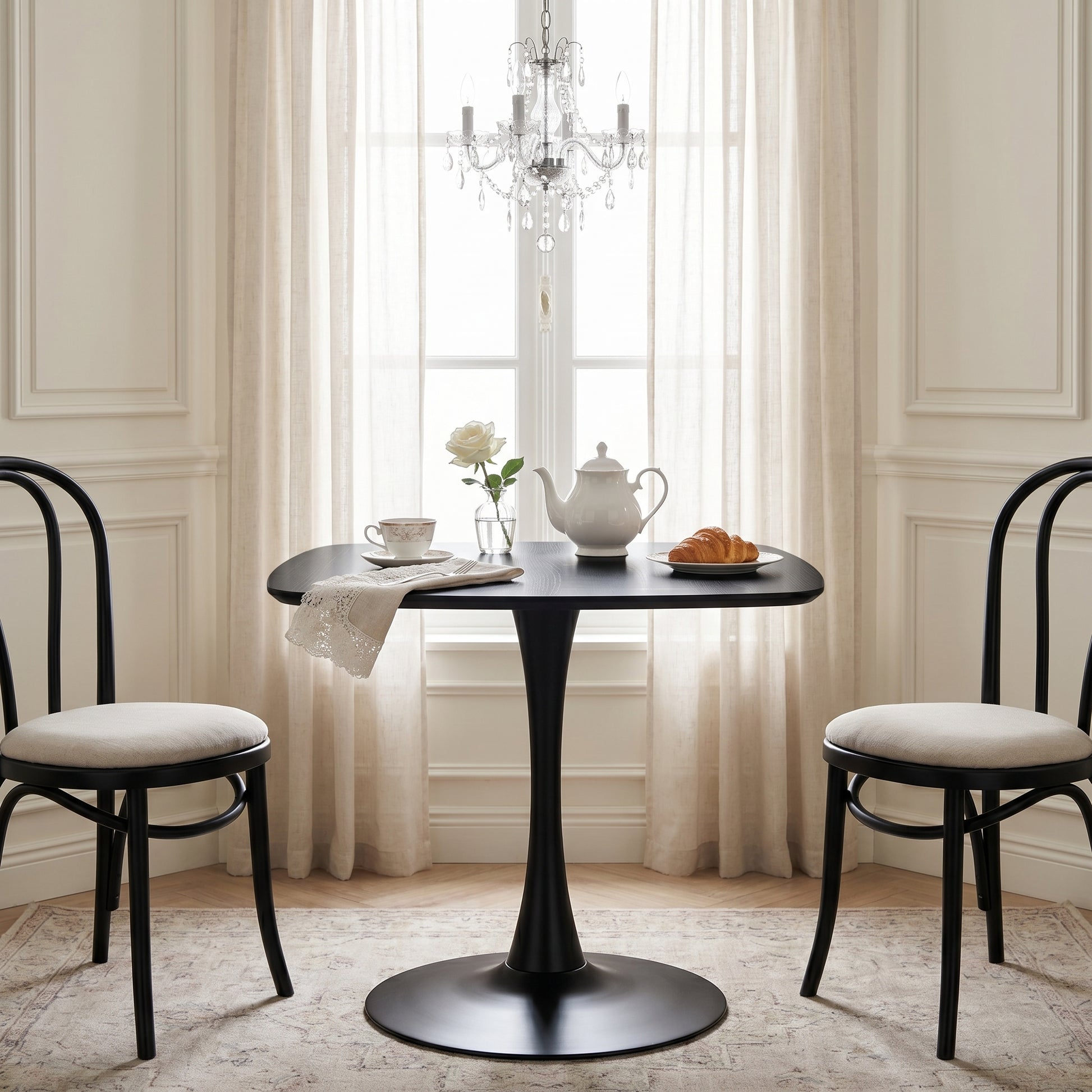 Santorini black dining table showing a cozy dining room with floral centerpiece