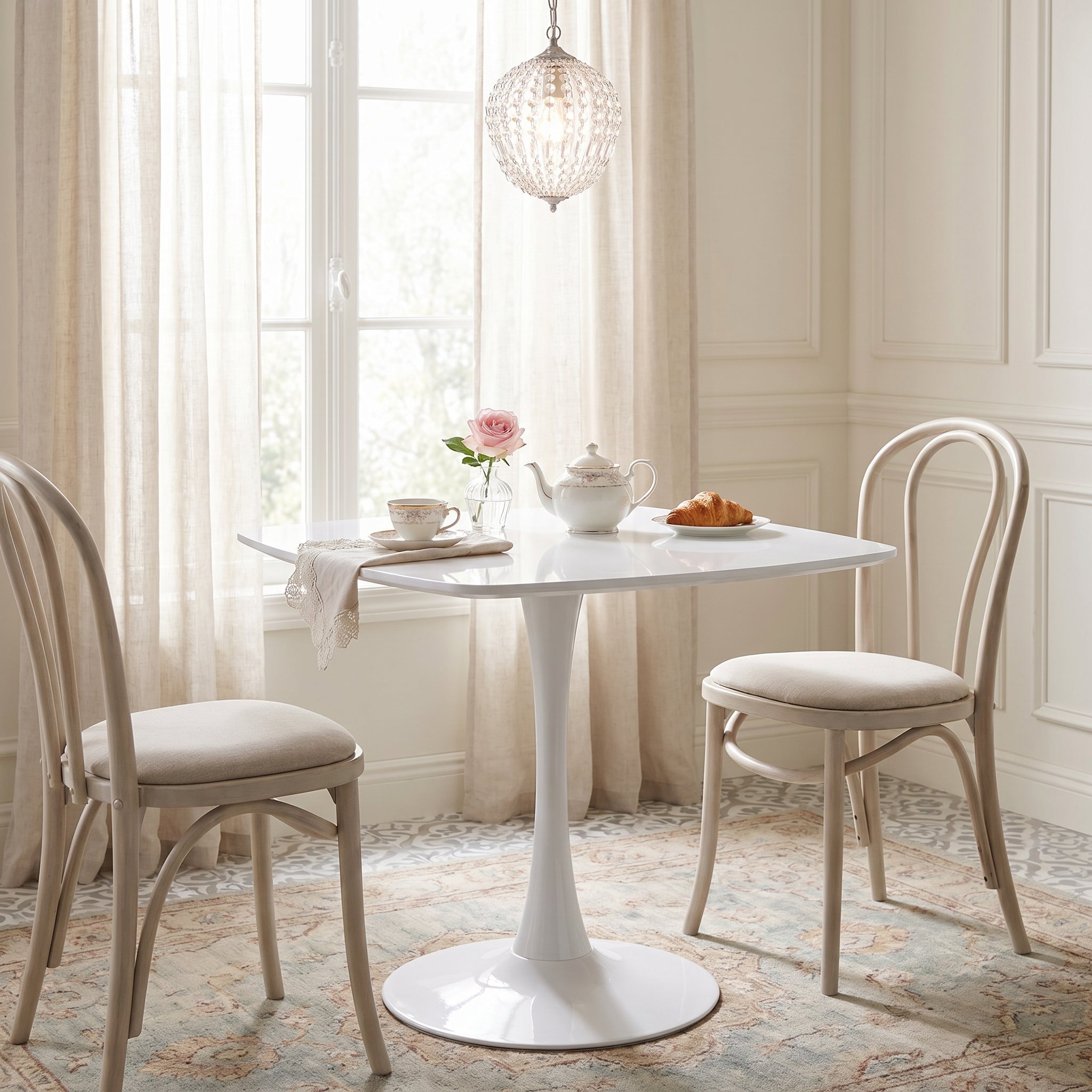 Santorini white dining table showing a styled dining space with upholstered chairs
