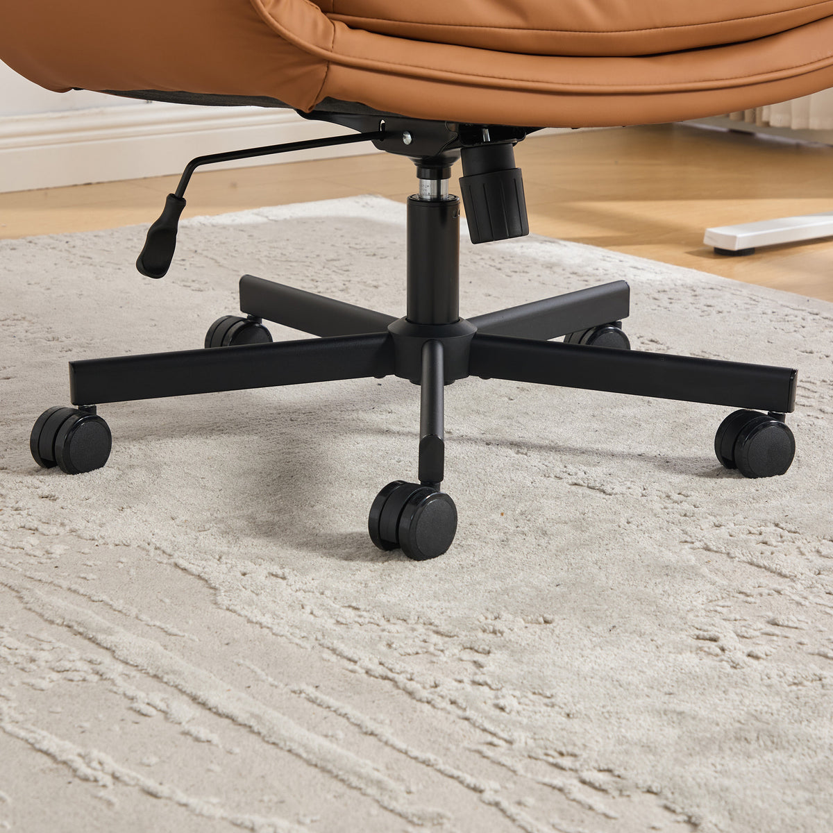 Selva brown office chair showing swivel base detail